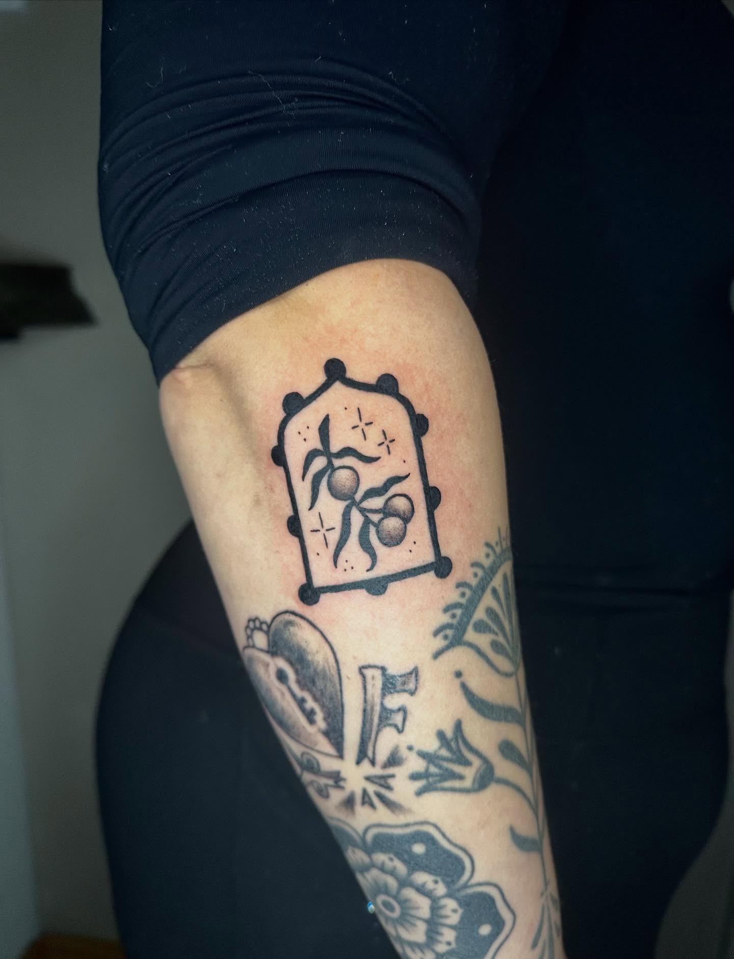 Fruit and leaves black and grey tattoo on the forearm by Jadelin, San Francisco, California