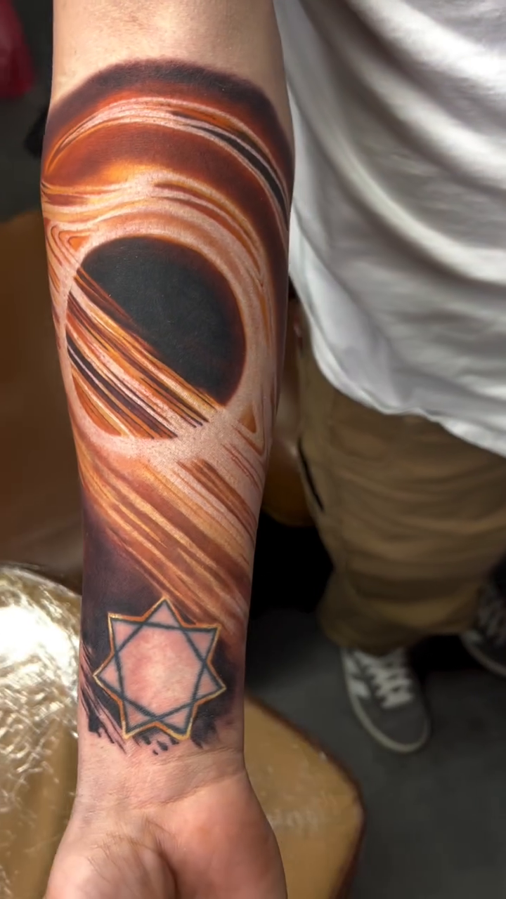 Black hole and star realism tattoo by Adam Zgorliski_STStattoo