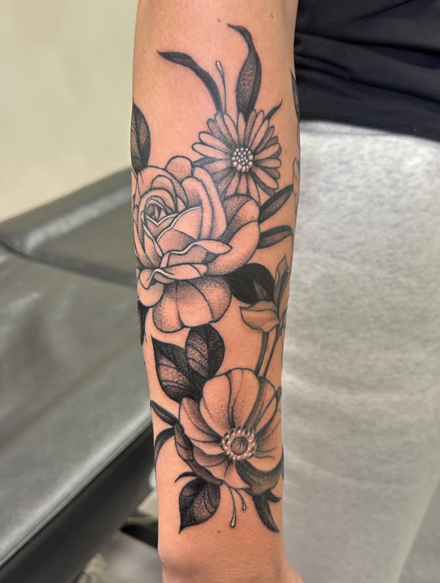 Floral bouquet black and grey tattoo on the forearm by kuna ink