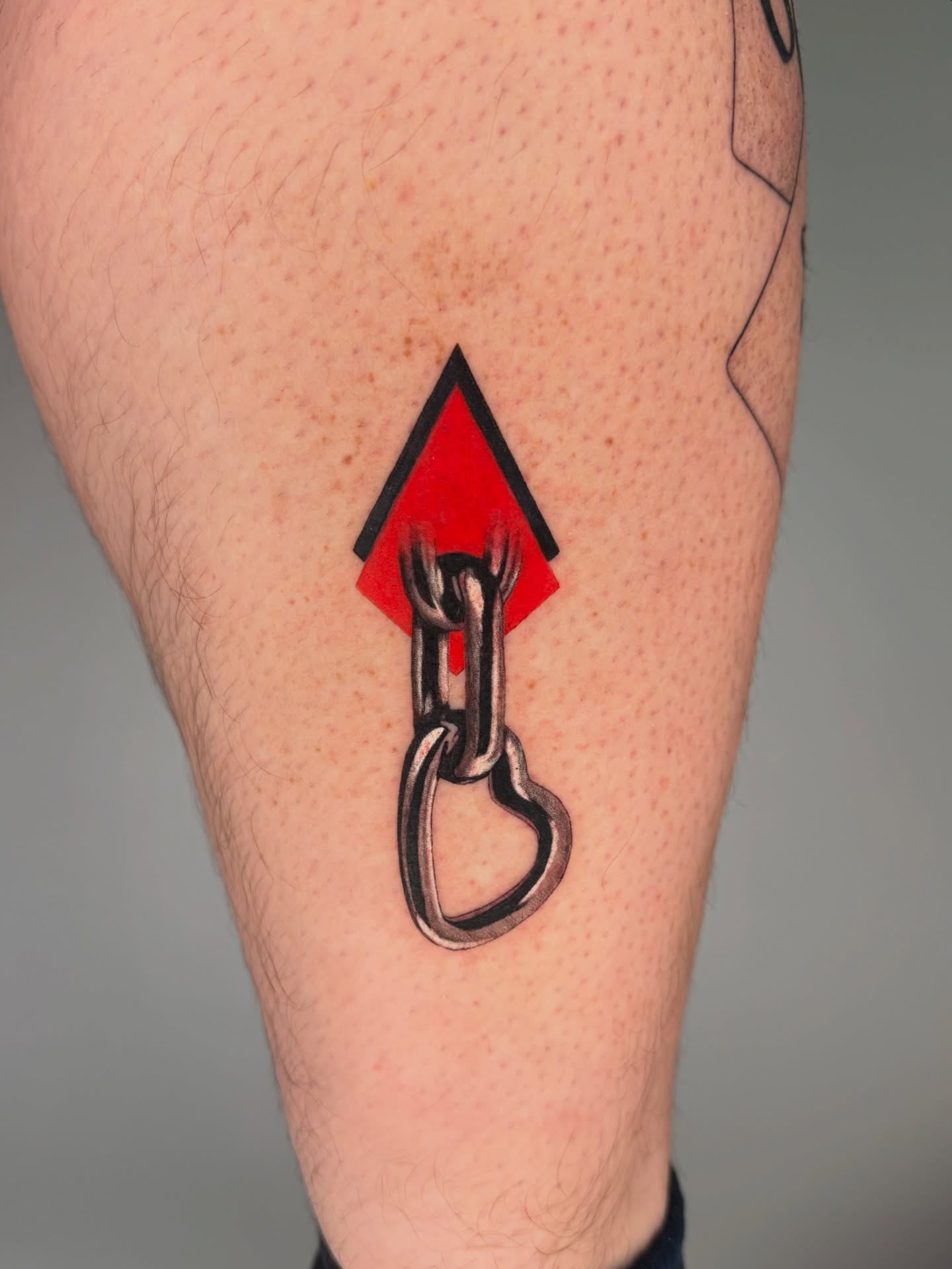 Spade and chain geometric tattoo on the leg by Jerm Lewis