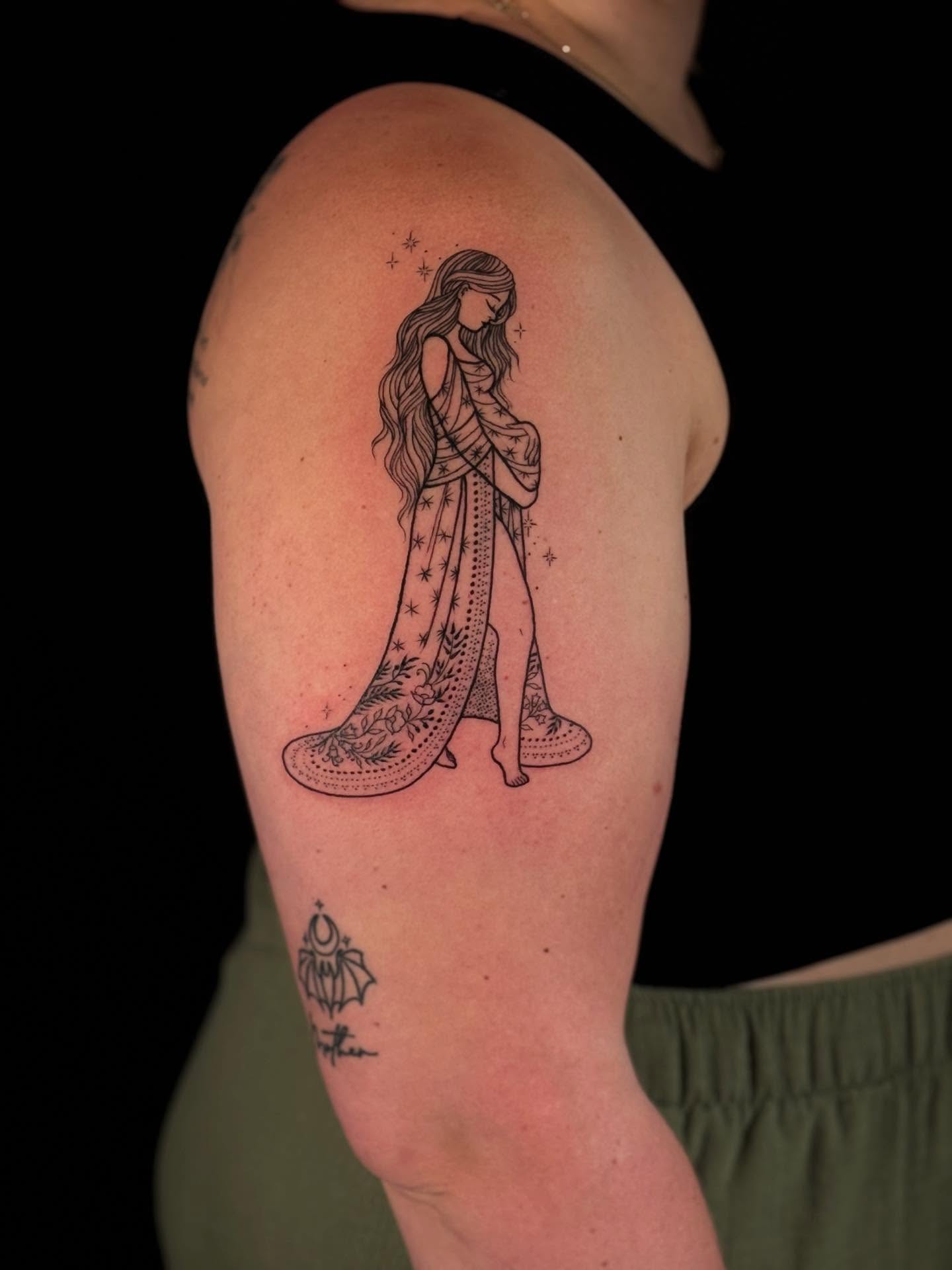 Woman in dress fine line tattoo on the shoulder by Annie Mess