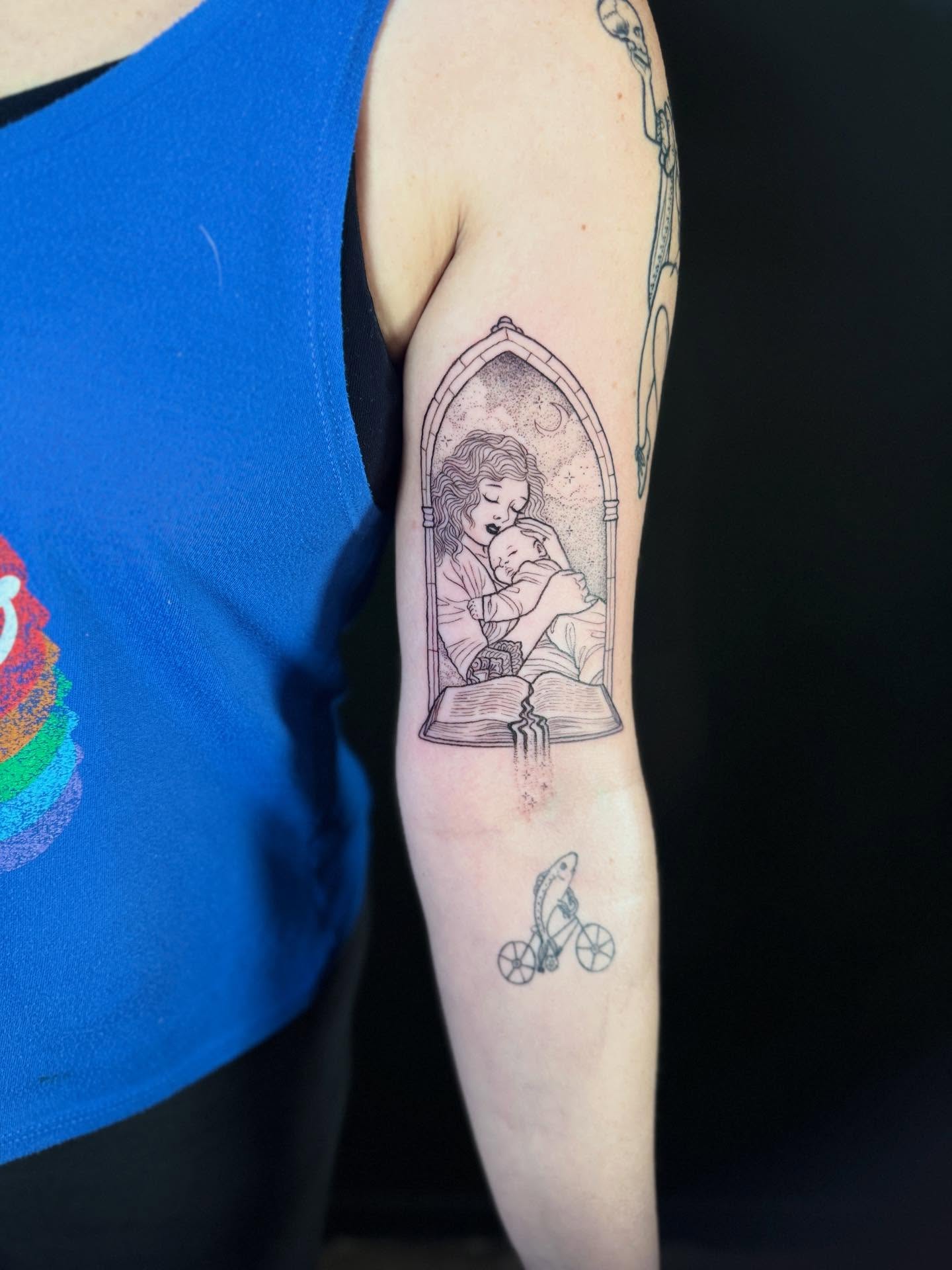 Mother and child reading realism tattoo on the forearm by Annie Mess