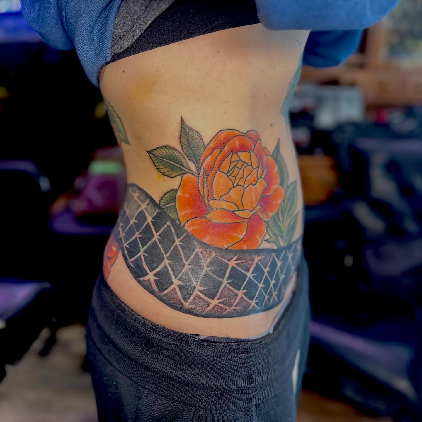 Rose American traditional tattoo on the ribs by Leeuh Vandever