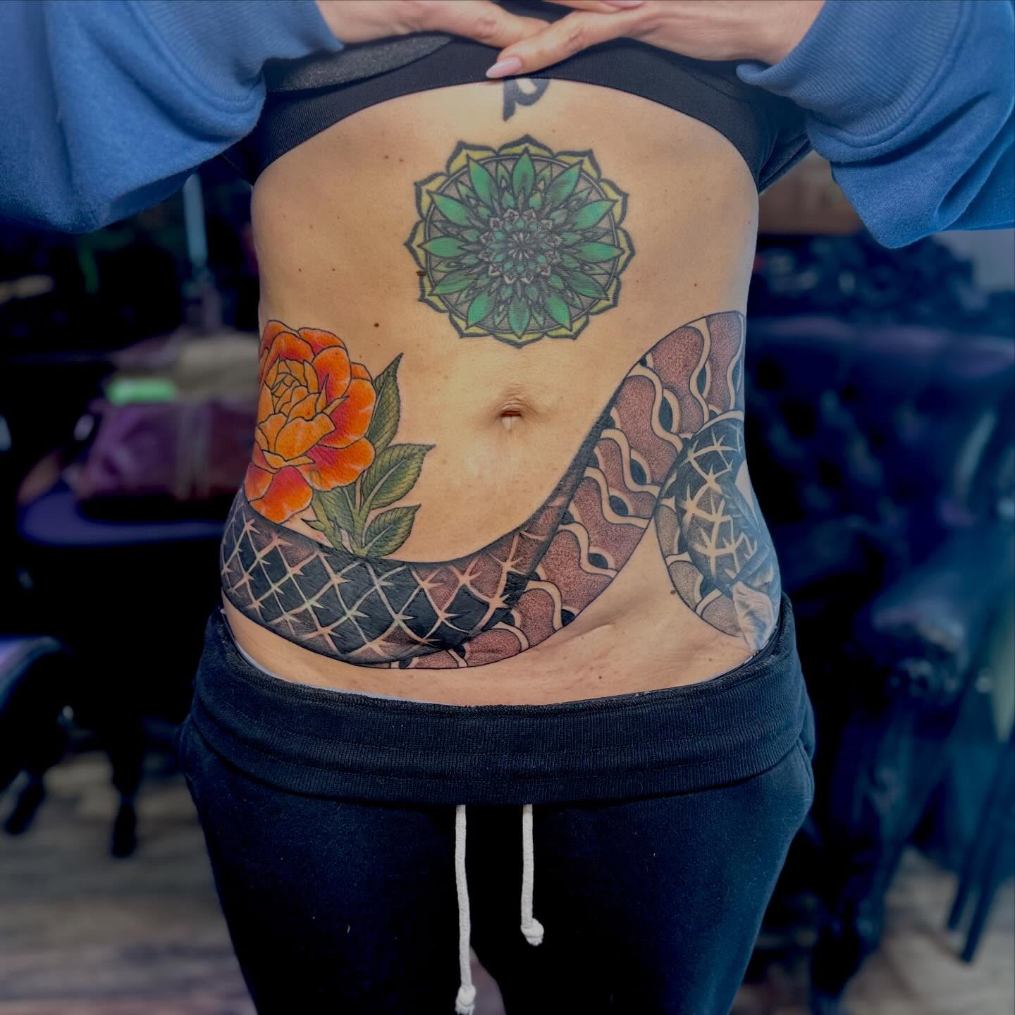 Snake and peony American traditional tattoo on the torso by Leeuh Vandever
