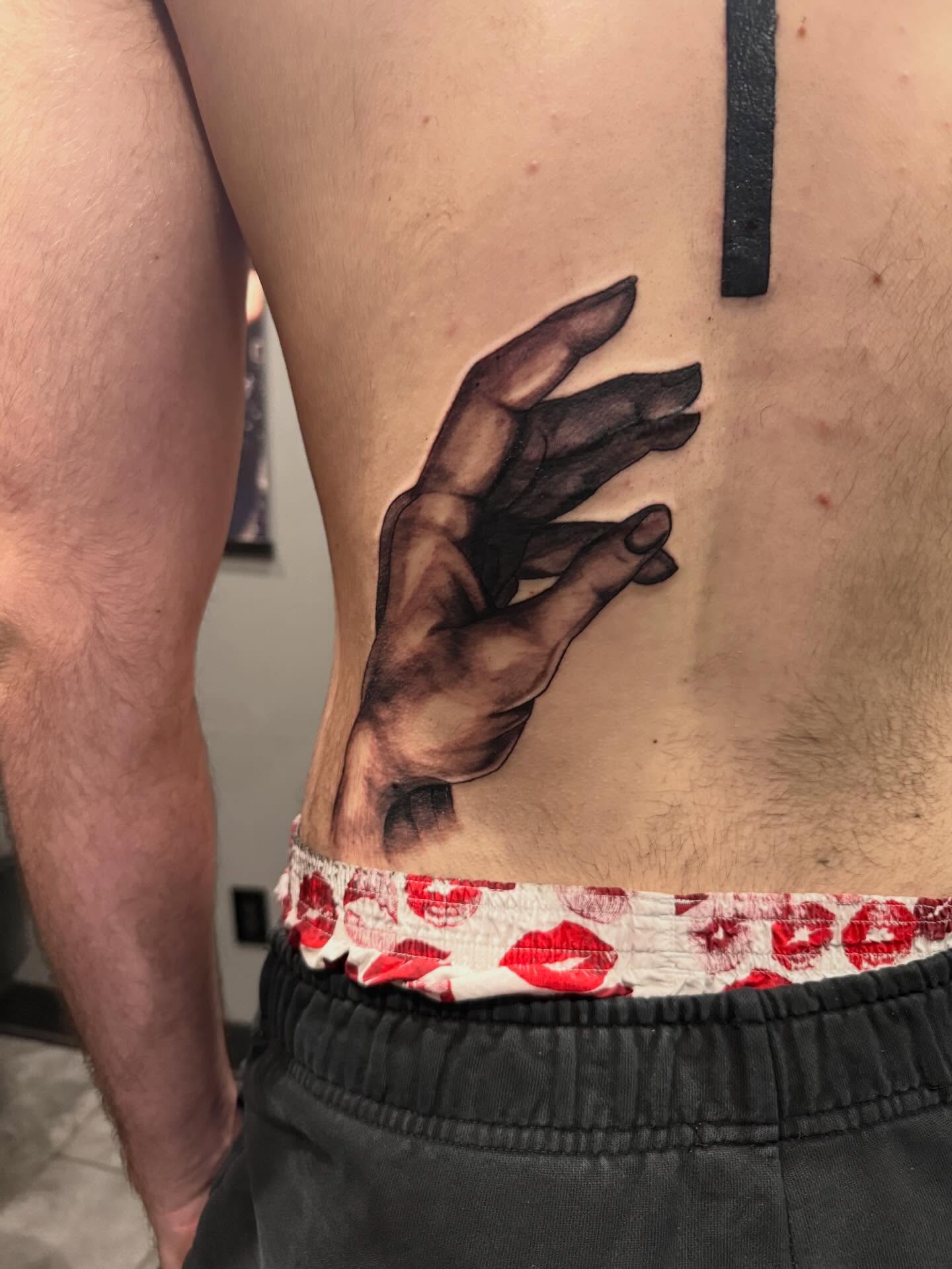 Hand realism tattoo on the ribs by Courtney