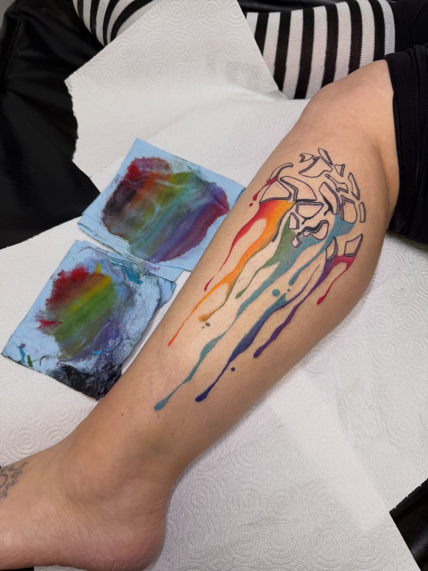 Abstract watercolor splash watercolor tattoo on the forearm by Dani Fried Tattoos