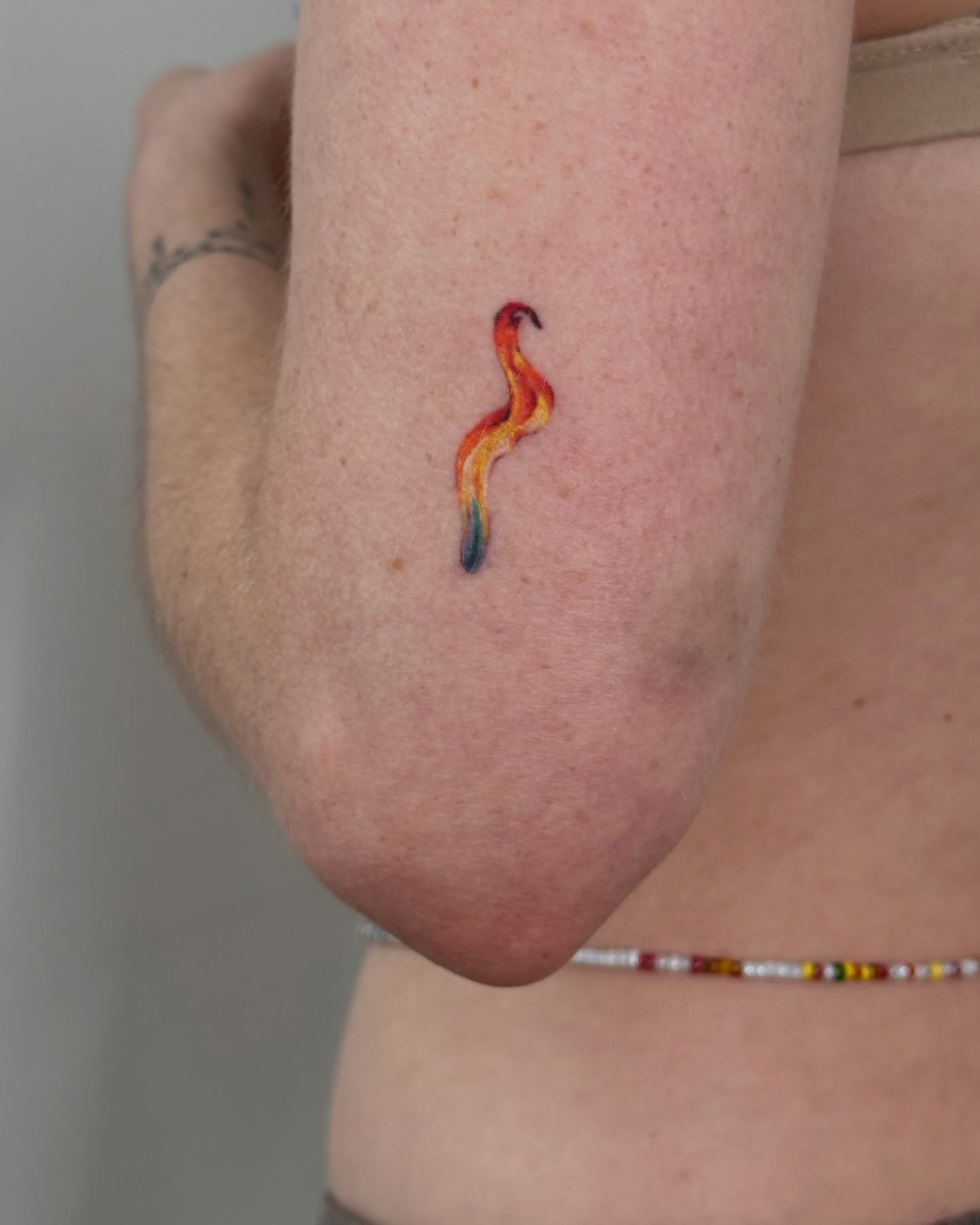 Flame watercolor tattoo on the forearm by Soohee Jin✨ NYC tattoo artist