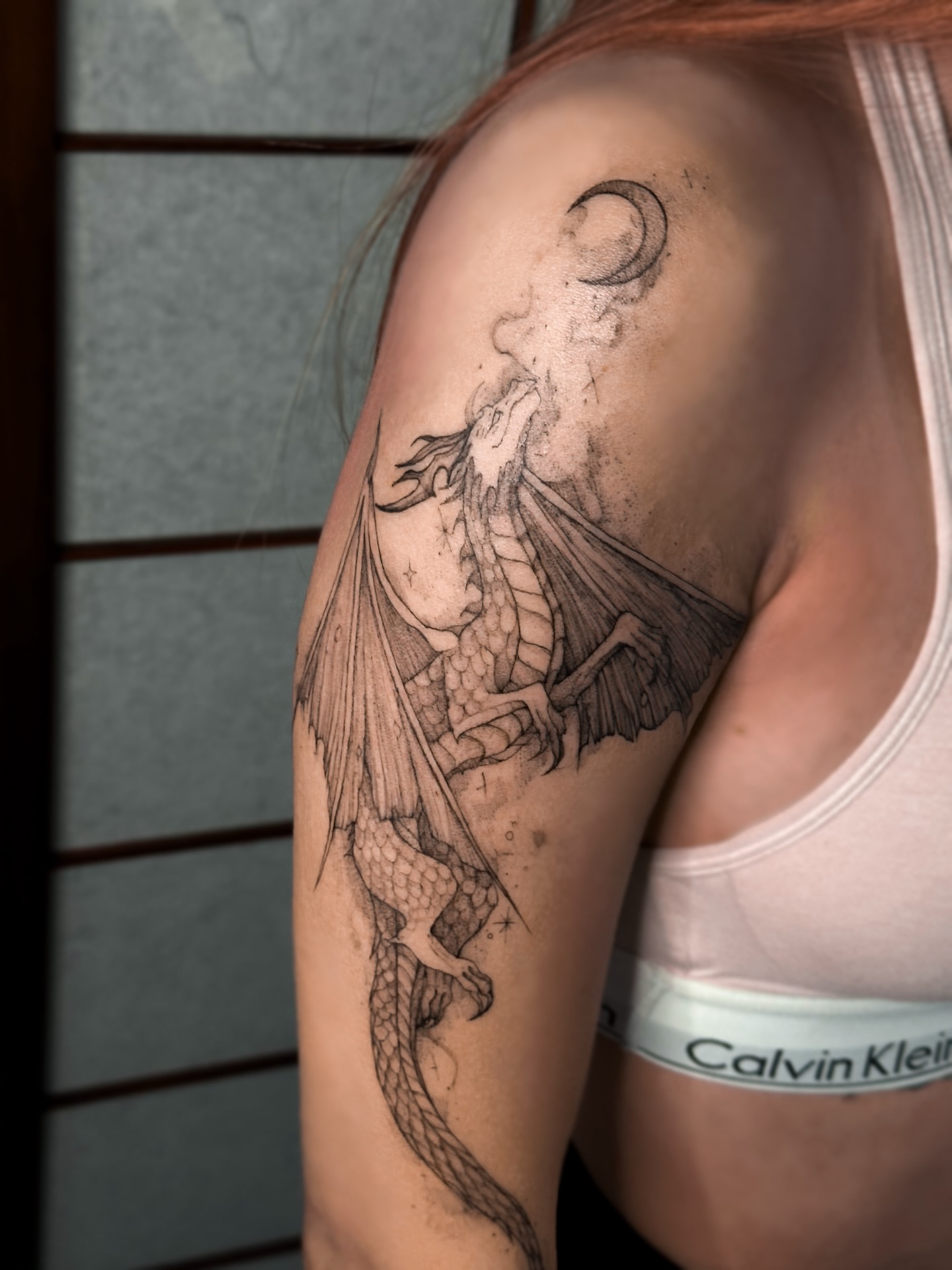 Dragon black and grey tattoo on the shoulder by Mila, Riga, Latvia