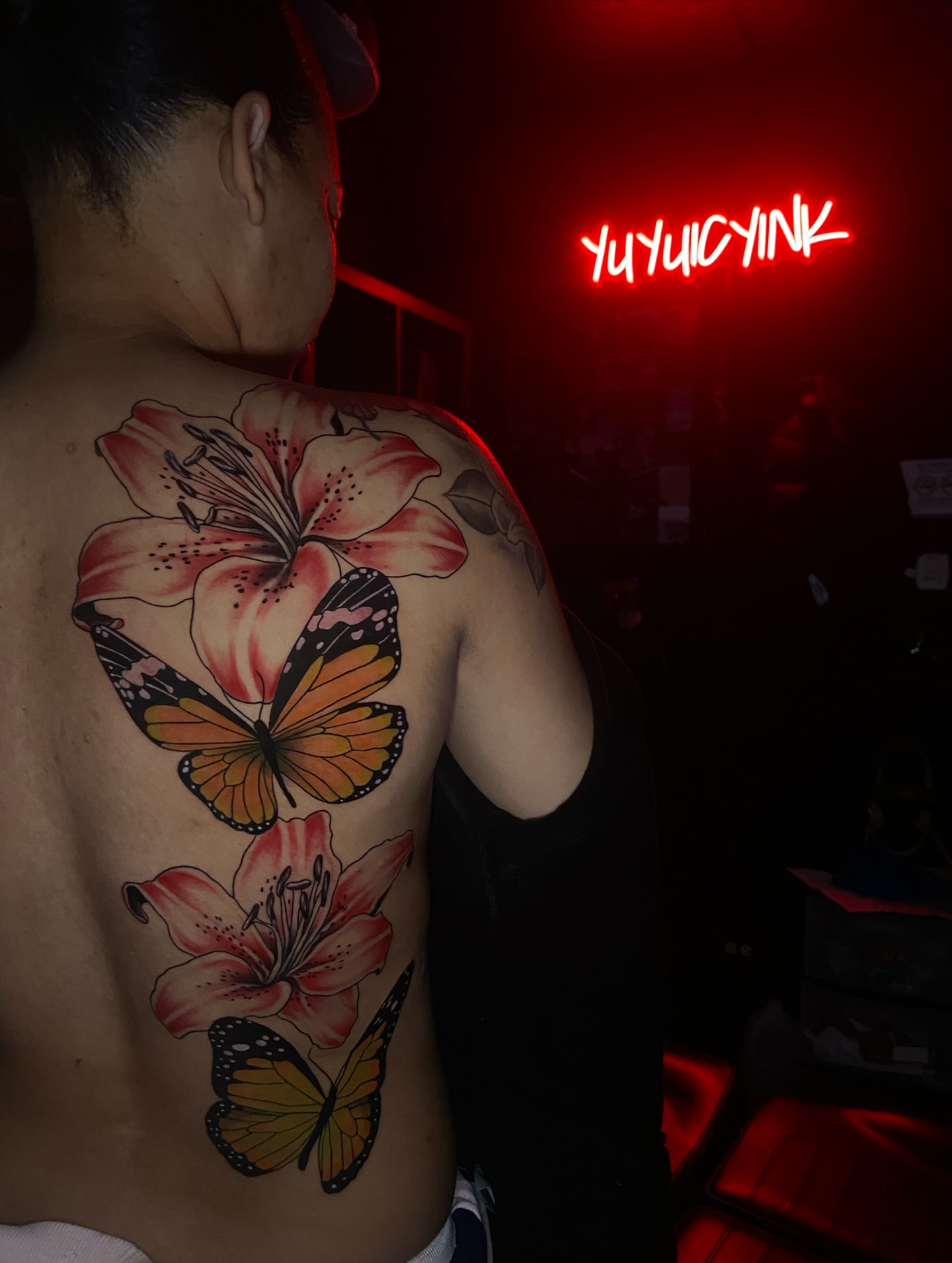 Lilies and butterflies new school tattoo on the back by Chicago Tattoo Artist