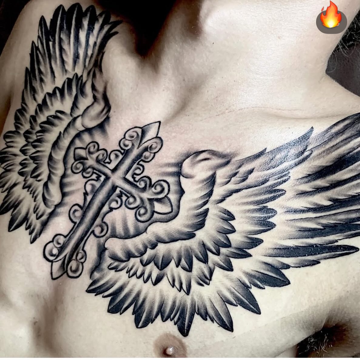 Cross with wings black and grey tattoo on the chest by Brandon Harrison, Kansas City, Missouri