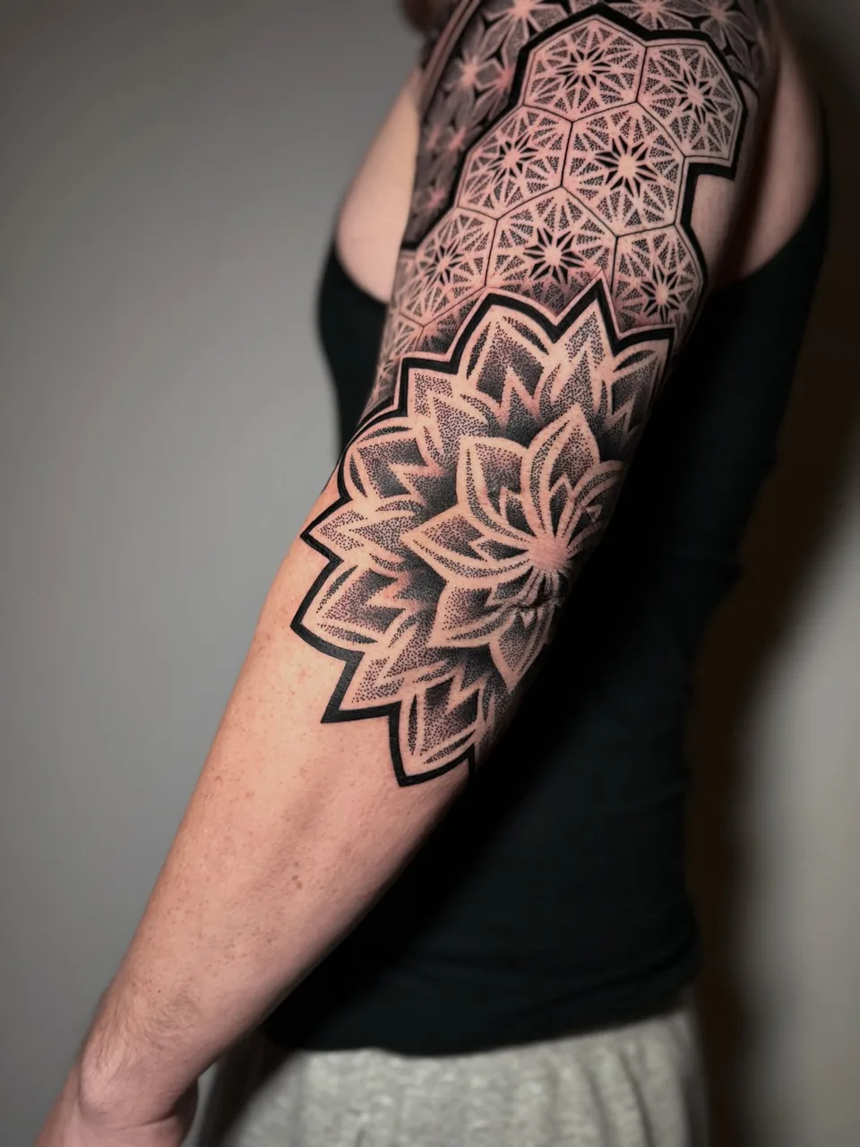 Geometric mandala dotwork tattoo on the forearm by David Mushaney