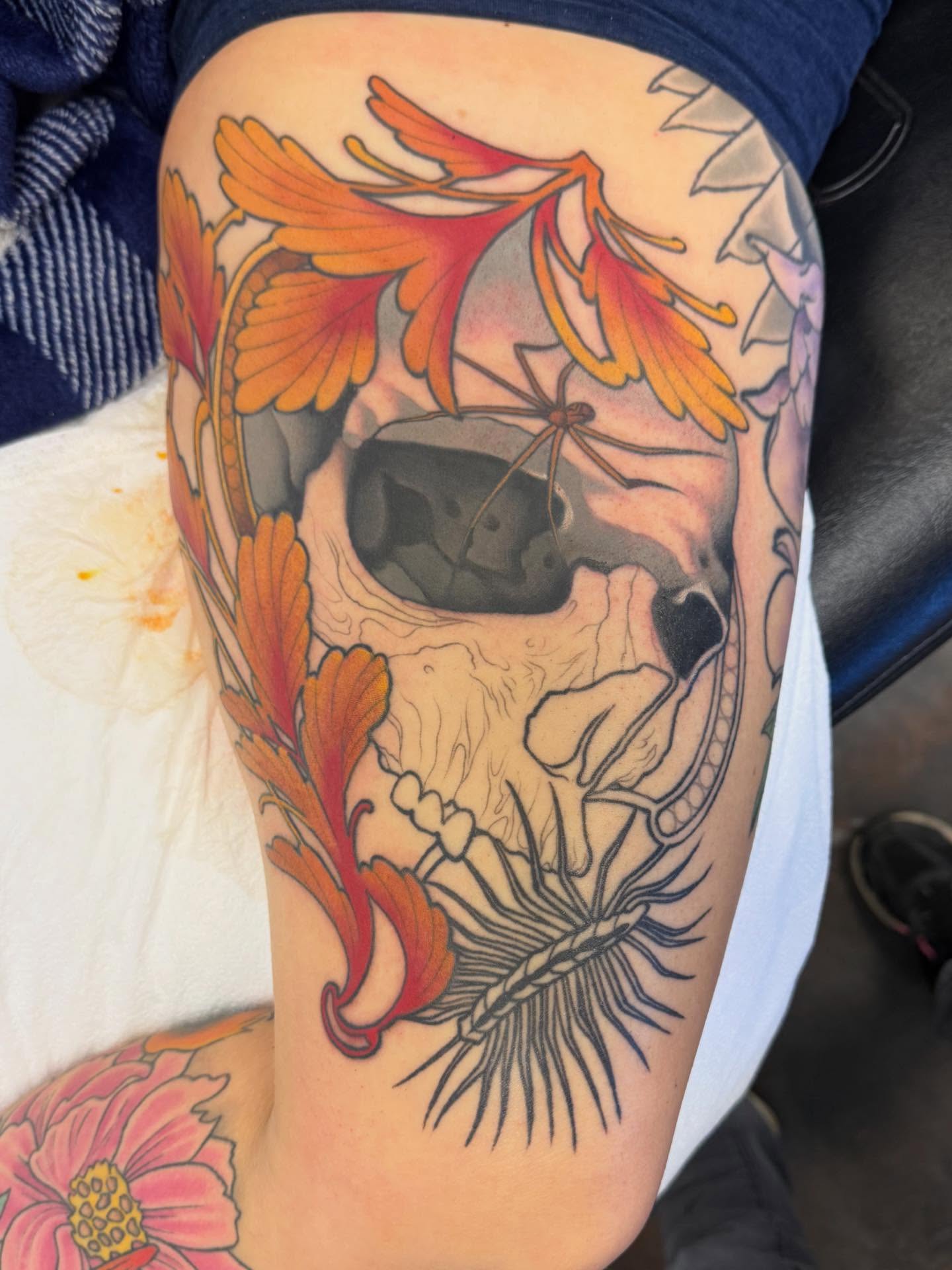 Skull with flowers American traditional tattoo on the thigh by Connie Fiorino - Tattoo Artist