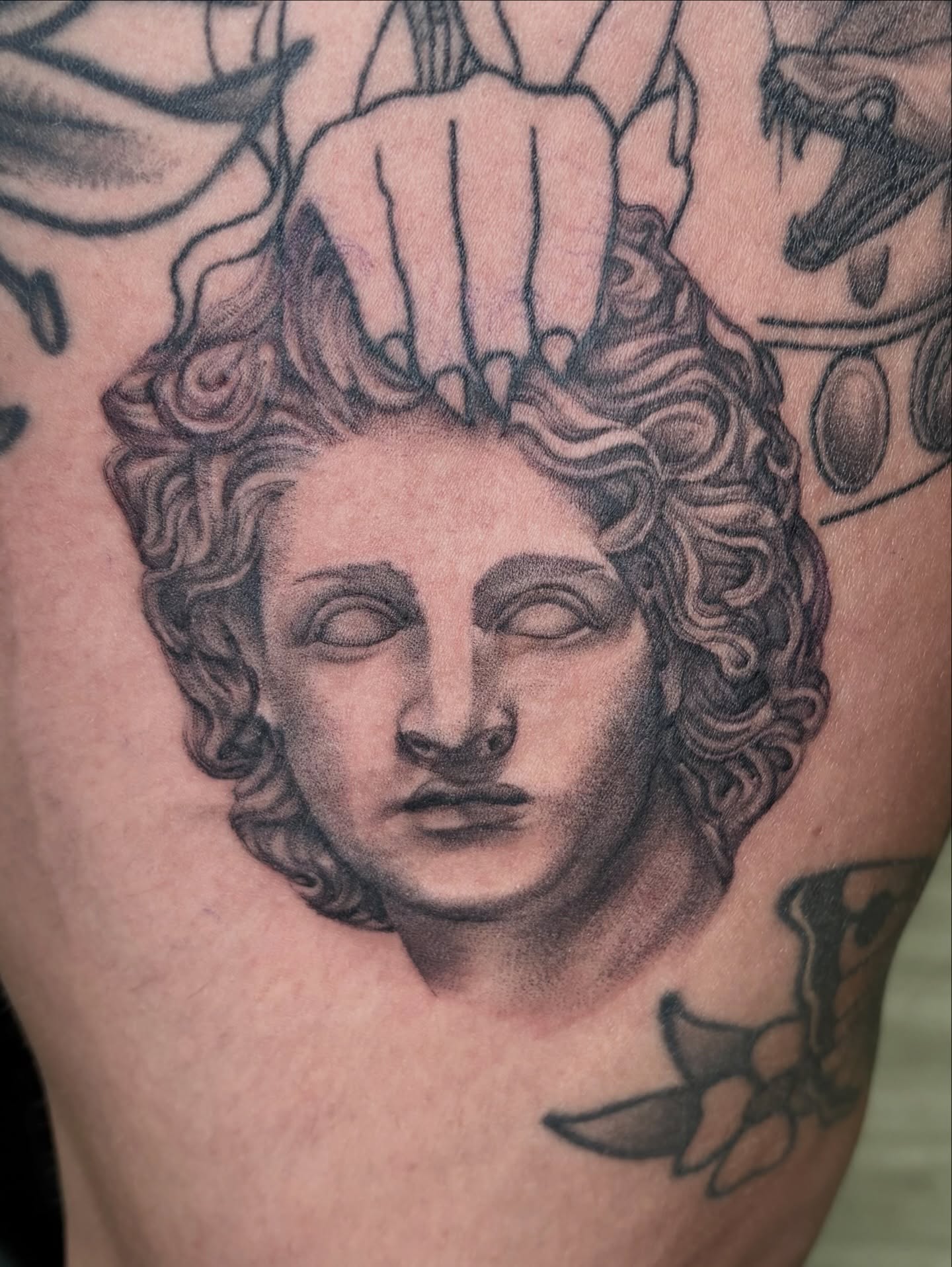 Statue head black and grey tattoo on the shoulder by hannah vertal