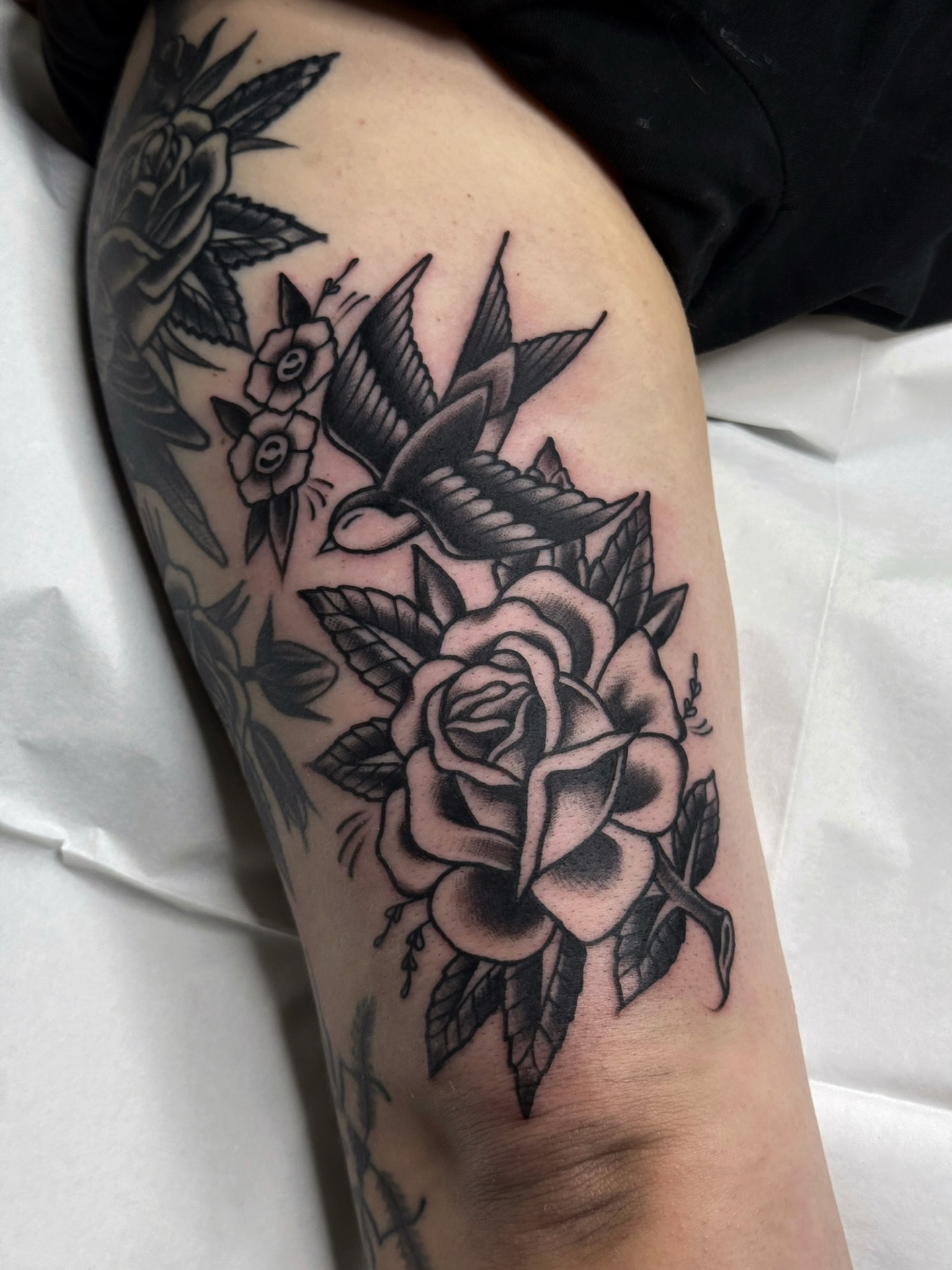 Rose and bird American traditional tattoo on the thigh by Trav, Bayville, New Jersey