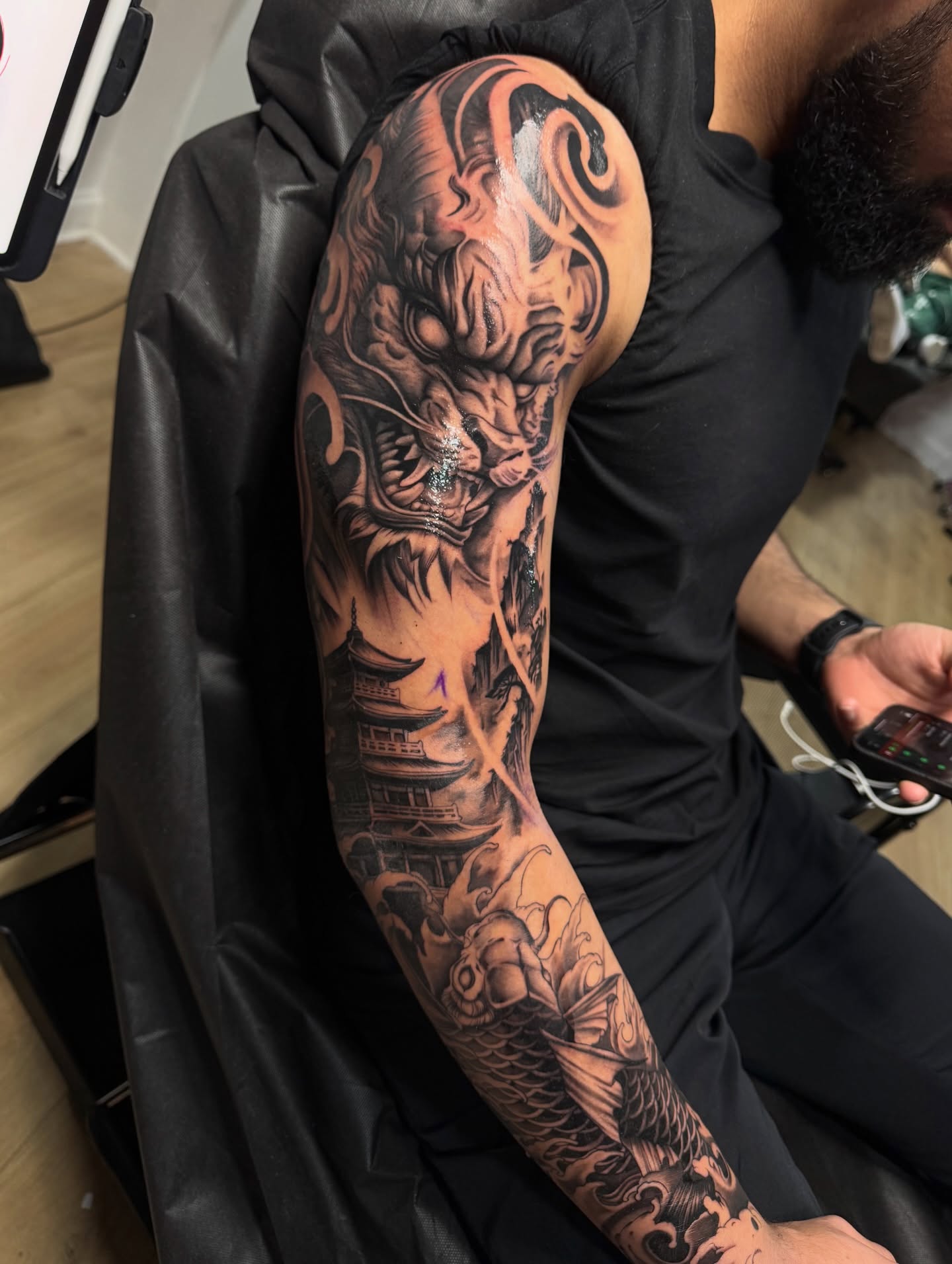 Mythical creature japanese irezumi tattoo on the upper arm by Flamure Islami