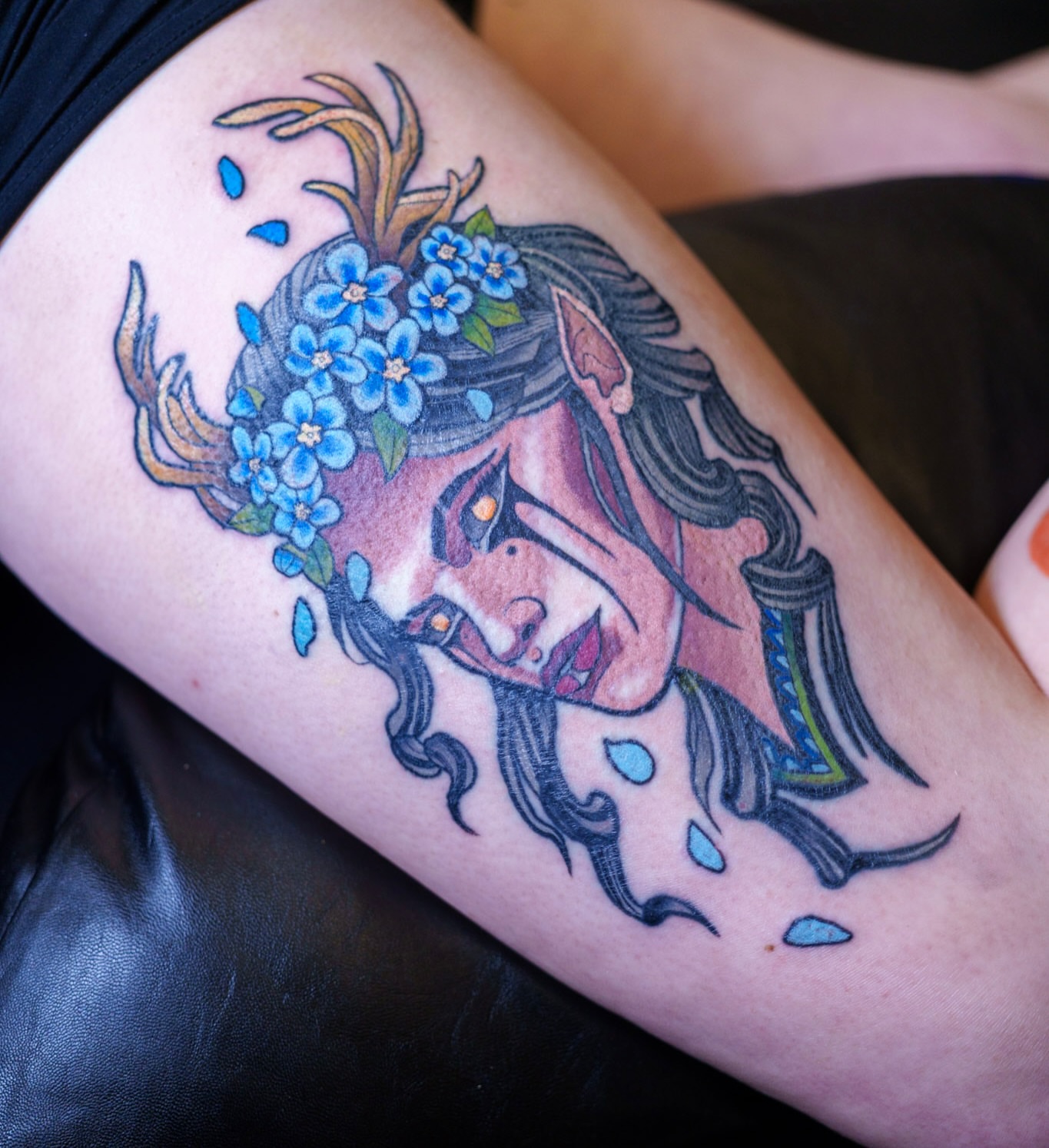 Woman with flowers American traditional tattoo on the thigh by Ben McKee