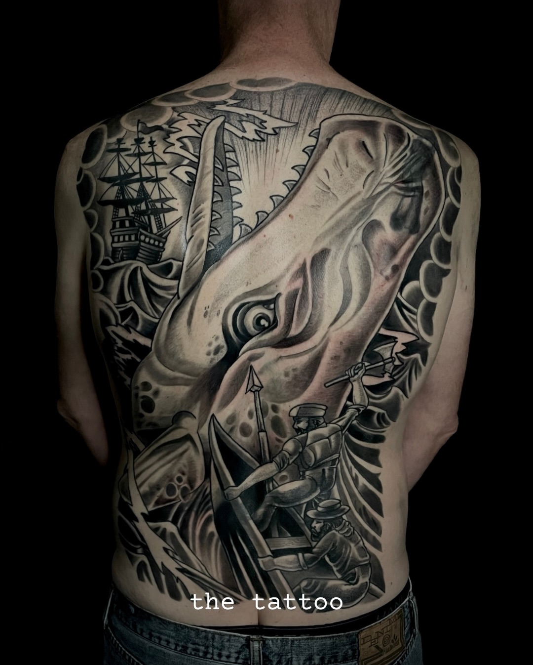 Dinosaur and ship realism tattoo on the back by Chris Cockrill
