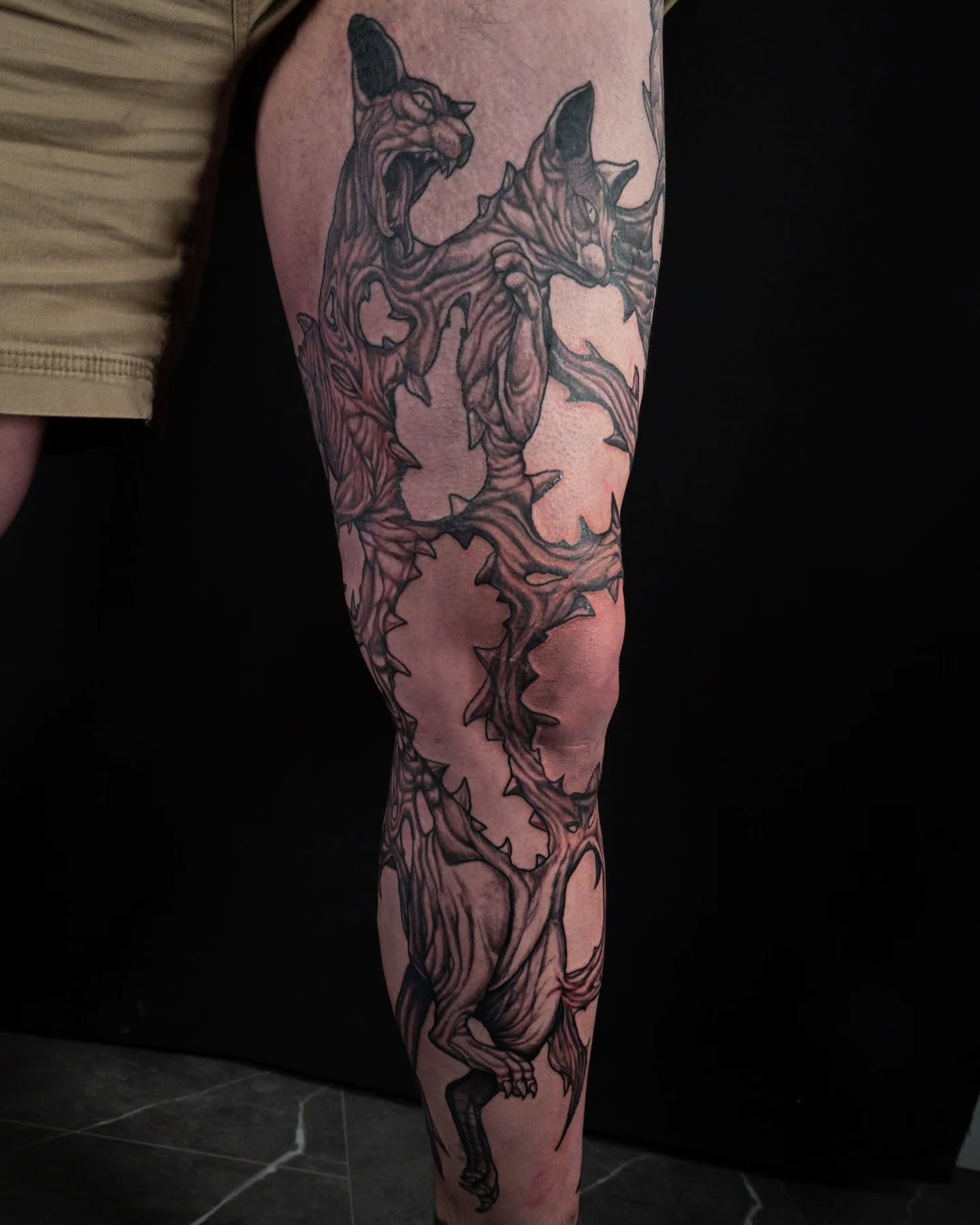 Demon black and grey tattoo on the leg by EyeSee Tattoos