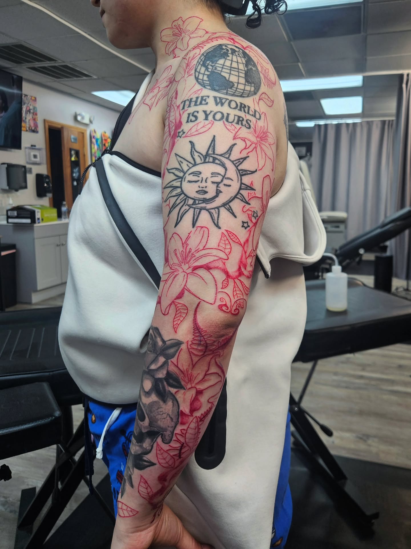 Solar motif with floral elements neo-traditional tattoo on the forearm by Damian Eames