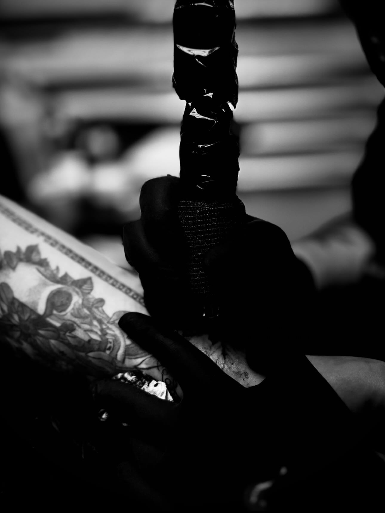Skull and floral American traditional tattoo on the forearm by Katelyn Arnold