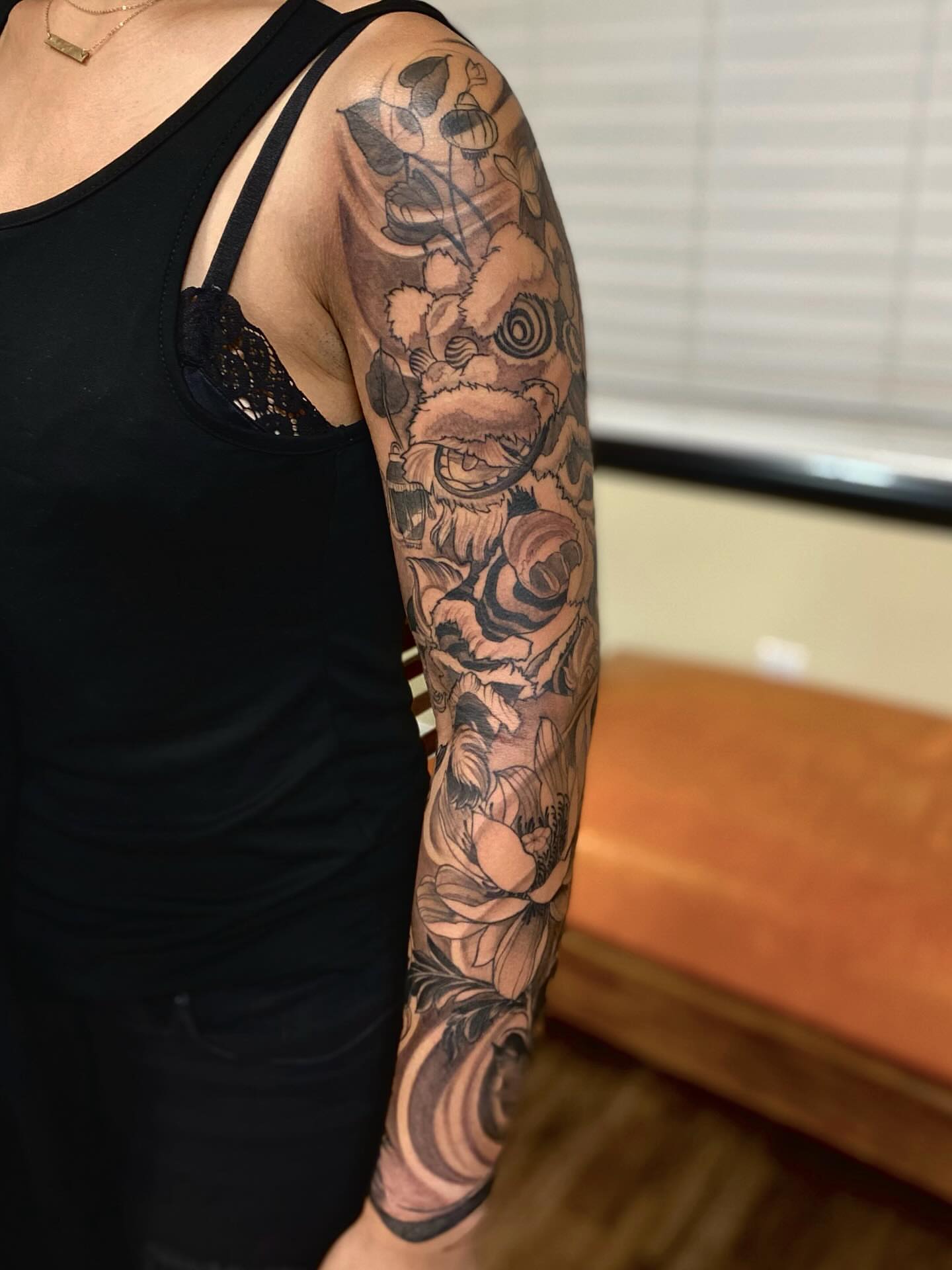 Floral bouquet japanese irezumi tattoo on the upper arm by Mathilda Quynh