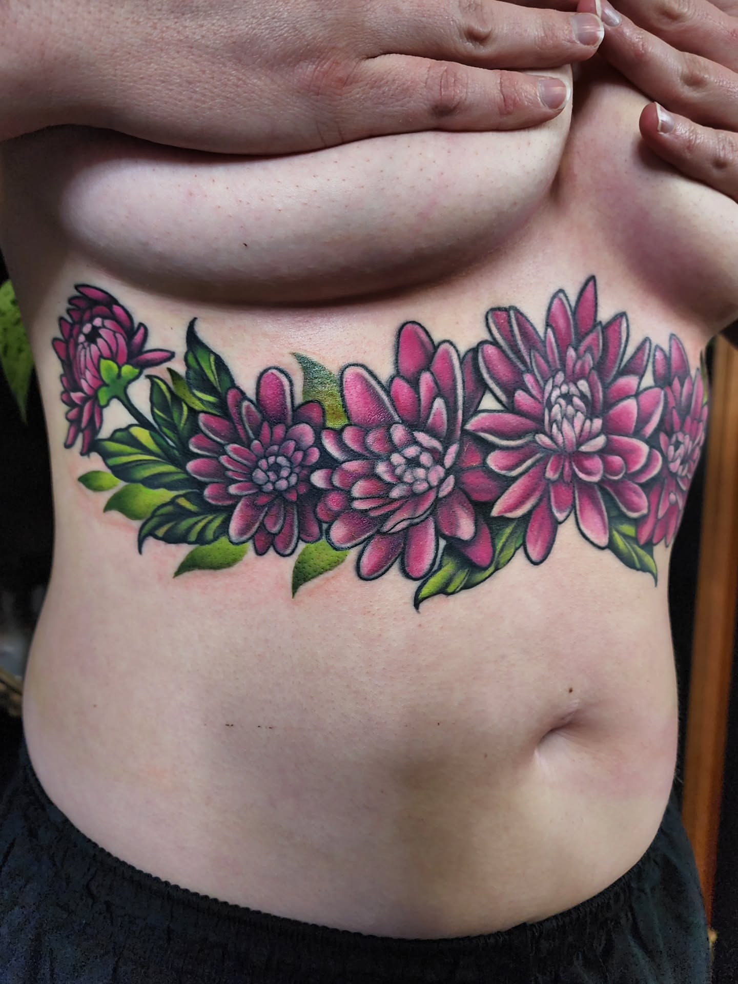 Dahlia flowers new school tattoo on the ribs by Shawna Goettsche