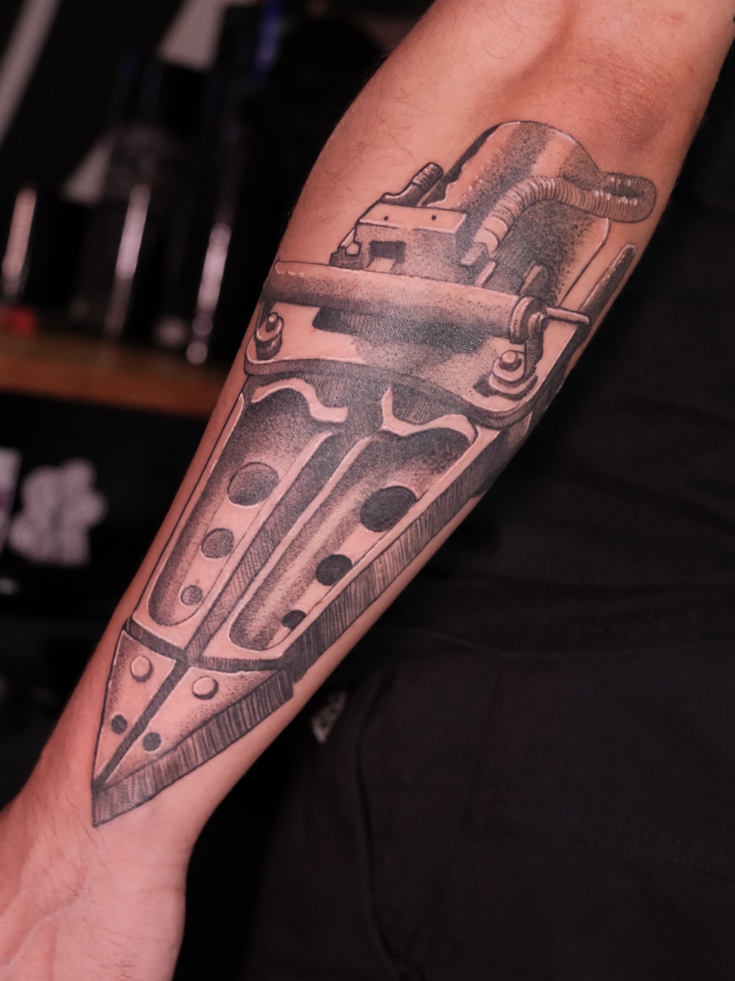 Gun black and grey tattoo on the forearm by Velvet, Seattle, Washington
