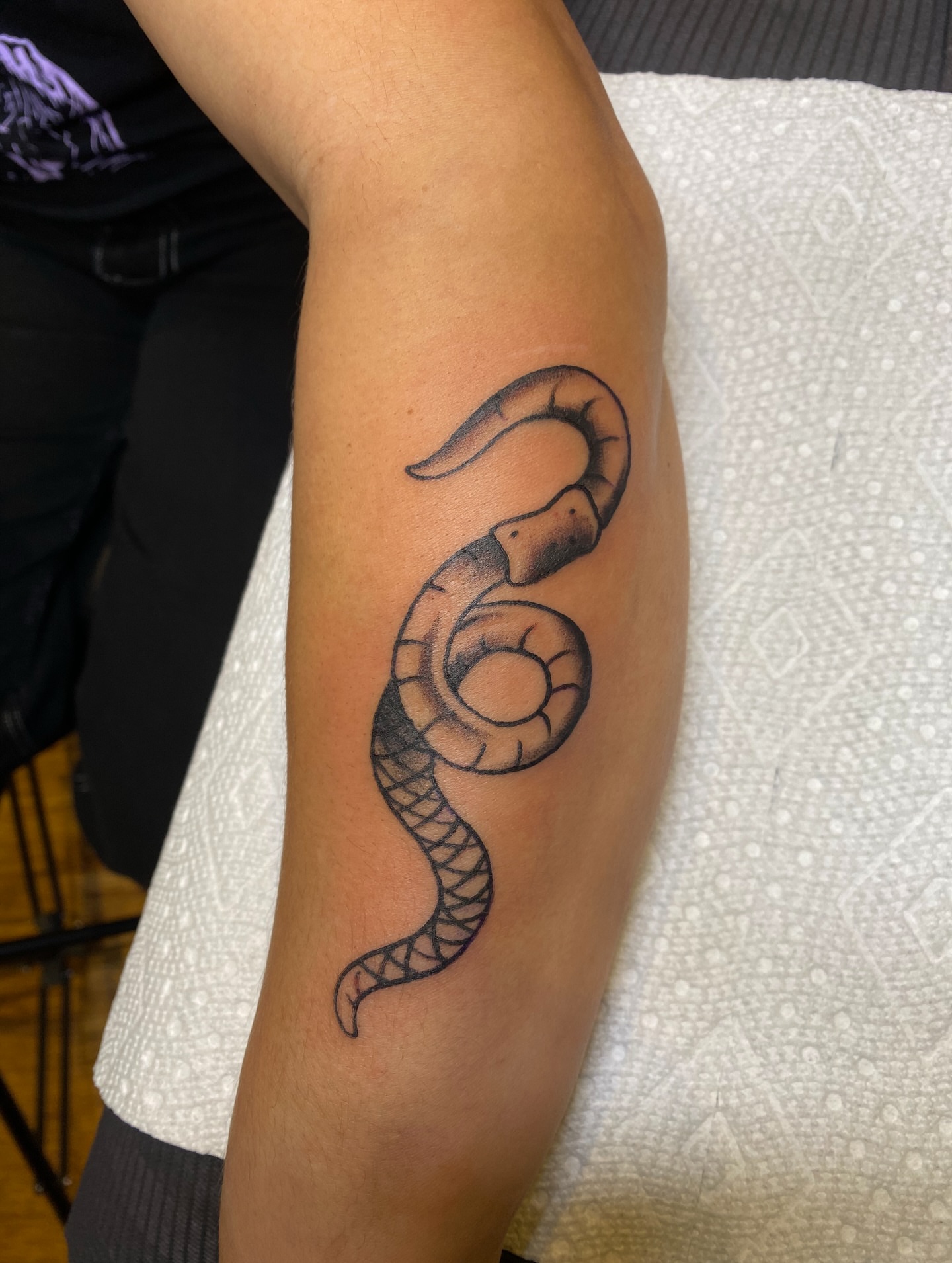 Snake black and grey tattoo on the forearm by Karl Hegwein, Portland, Oregon