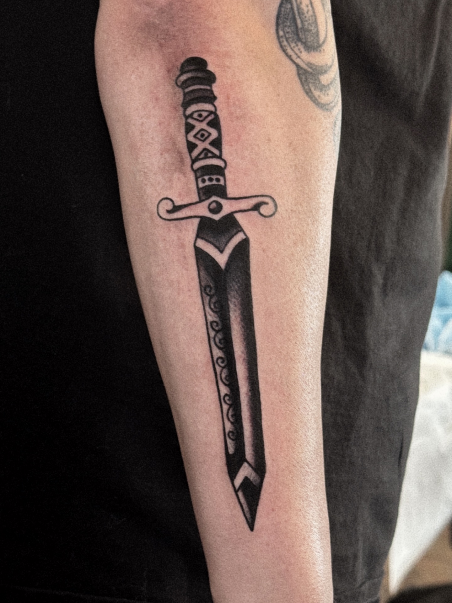 Sword black and grey tattoo on the forearm by Dylan Mott