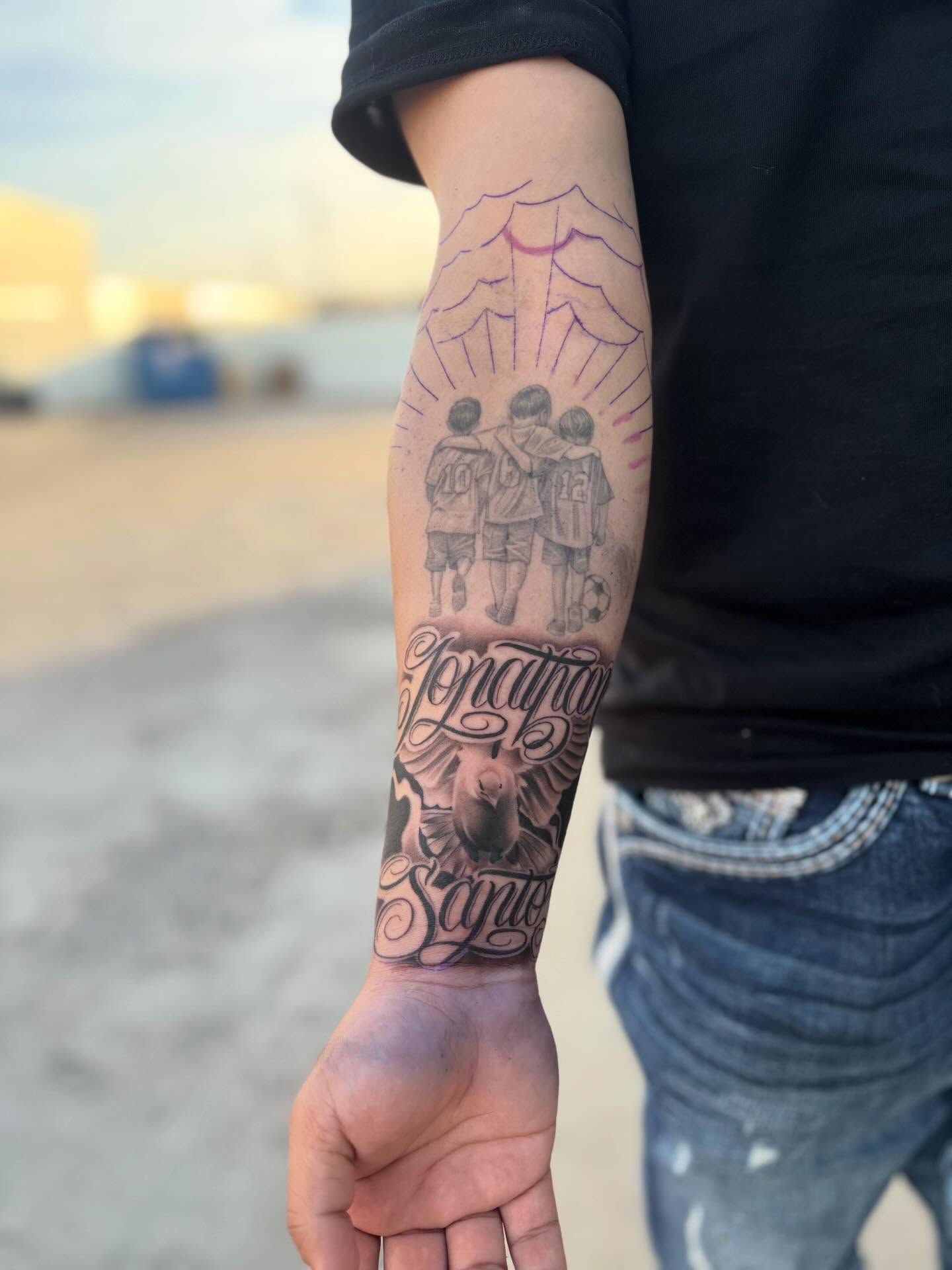 Football players black and grey tattoo on the forearm by Devin