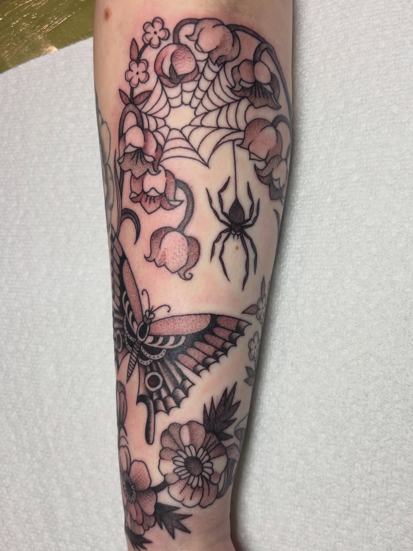 Flower and spider American traditional tattoo on the forearm by edith🌷, Murfreesboro, Tennessee