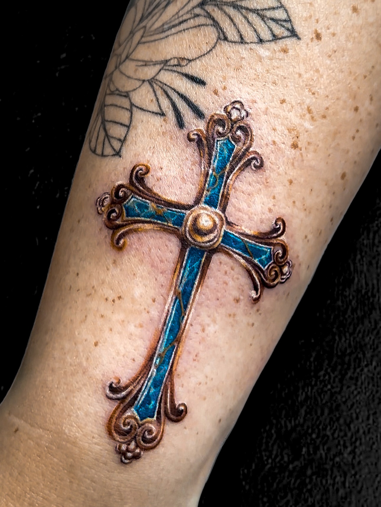 Cross ornamental tattoo on the forearm by Sincere