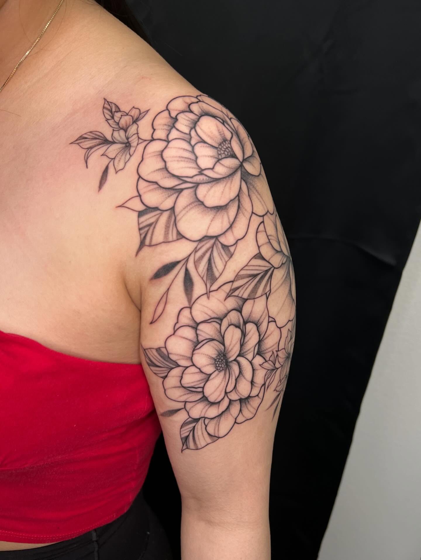 Floral bouquet black and grey tattoo on the shoulder by San Diego Fineline Black & Grey Tattoo Artist