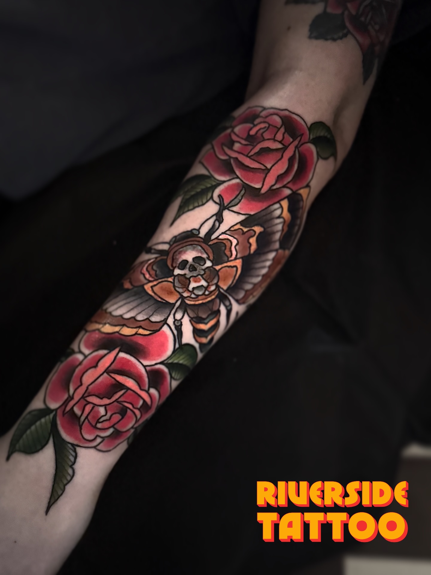 Roses and skull bee American traditional tattoo on the forearm by Stephen Shaw