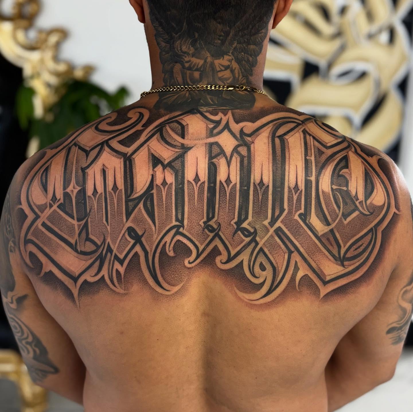 Gothic script lettering script tattoo on the back by Ashley brown, Las Vegas, Nevada