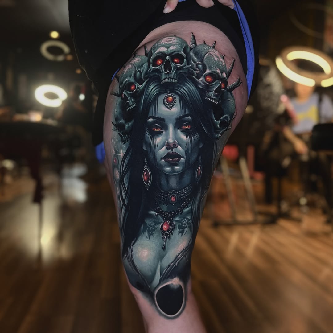 Gothic woman with skulls realism tattoo on the thigh by Bailey Hancock