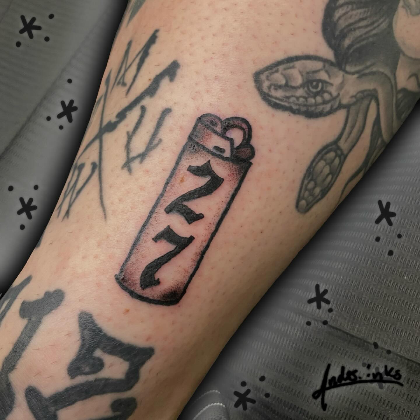Lighter black and grey tattoo on the forearm by ande