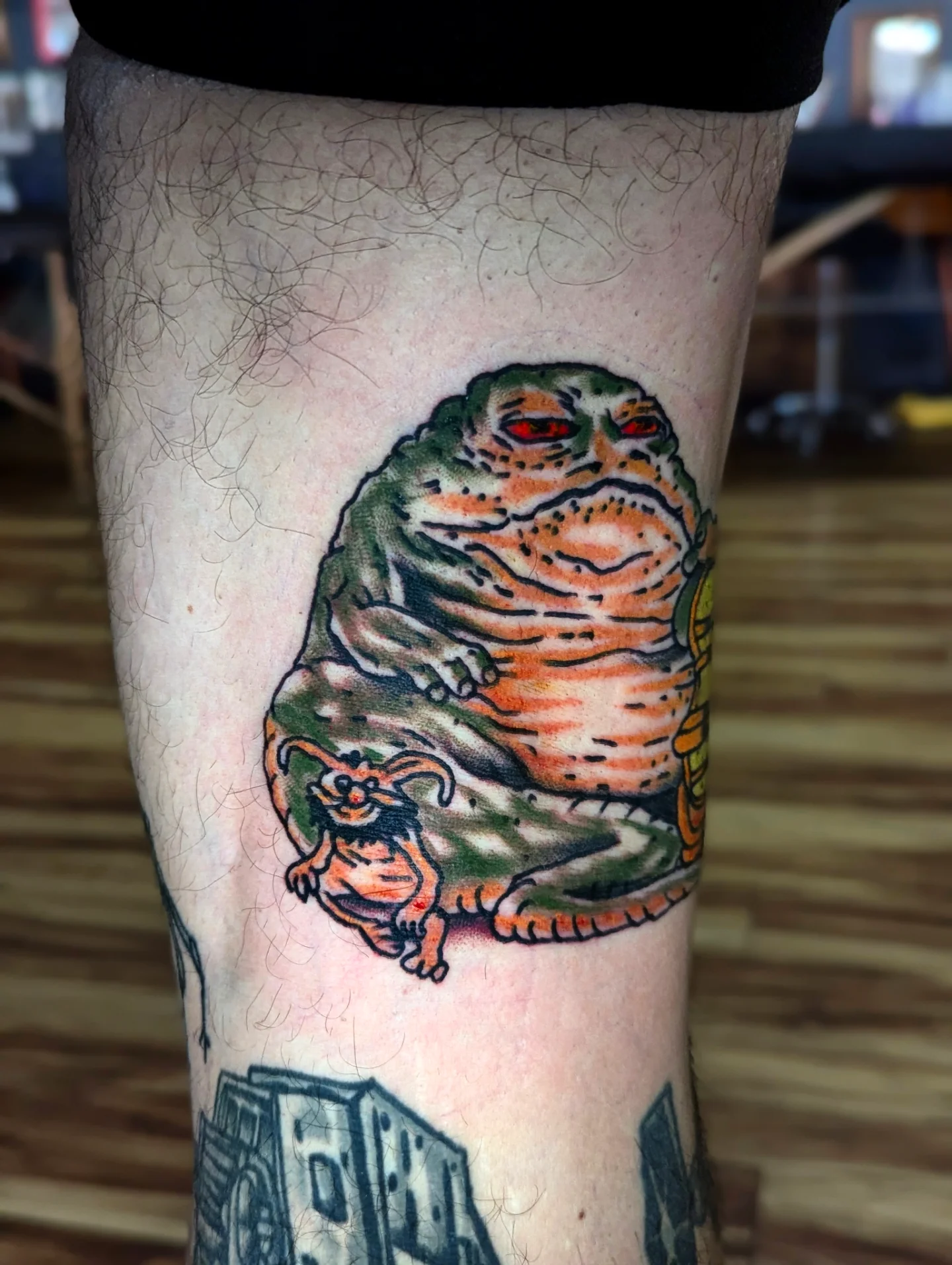 Jabba the hutt and slave girl American traditional tattoo on the forearm by Eric Ward