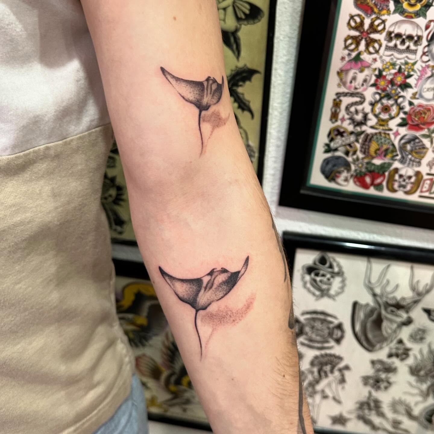Manta ray tail black and grey tattoo on the forearm by Kerri Colello Sittenauer