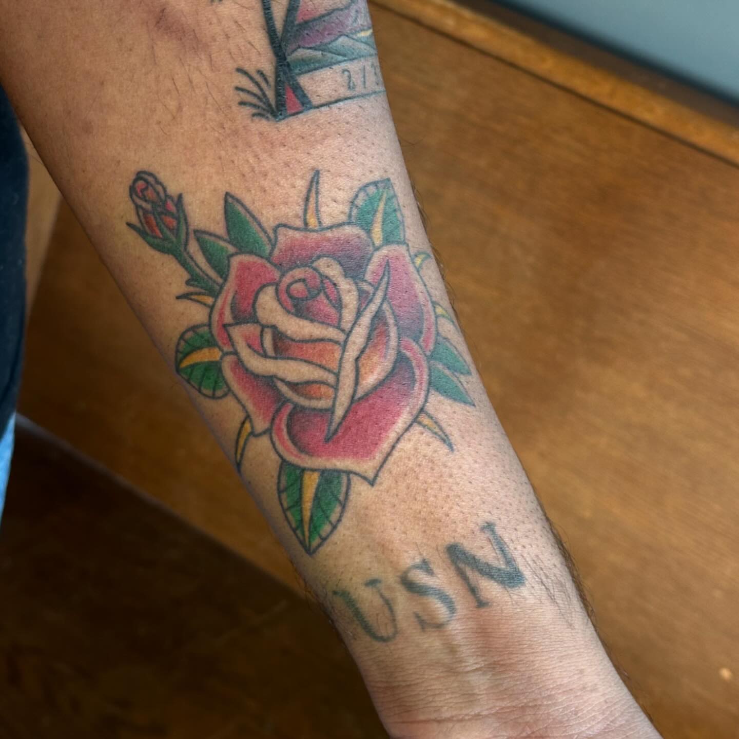 Rose American traditional tattoo on the forearm by Kerri Colello Sittenauer