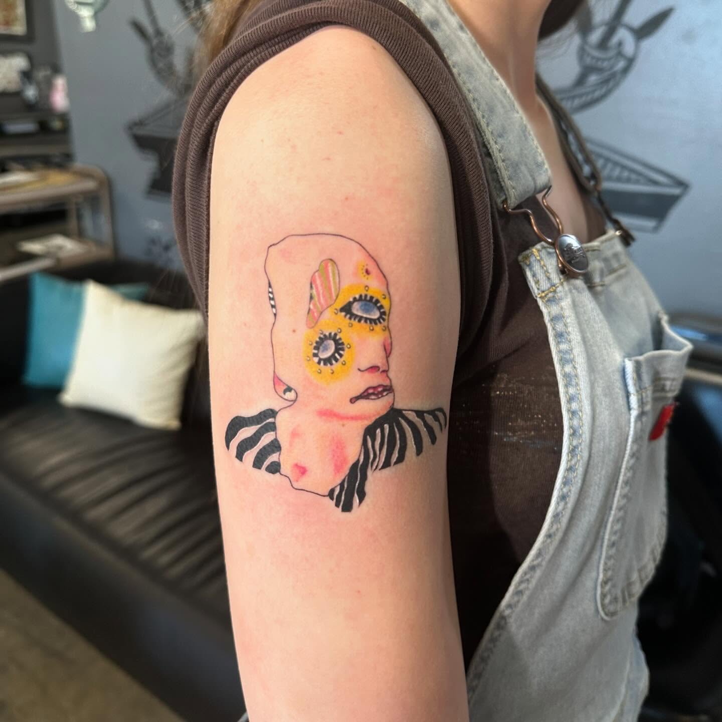 Abstract face surrealism tattoo on the forearm by Kerri Colello Sittenauer