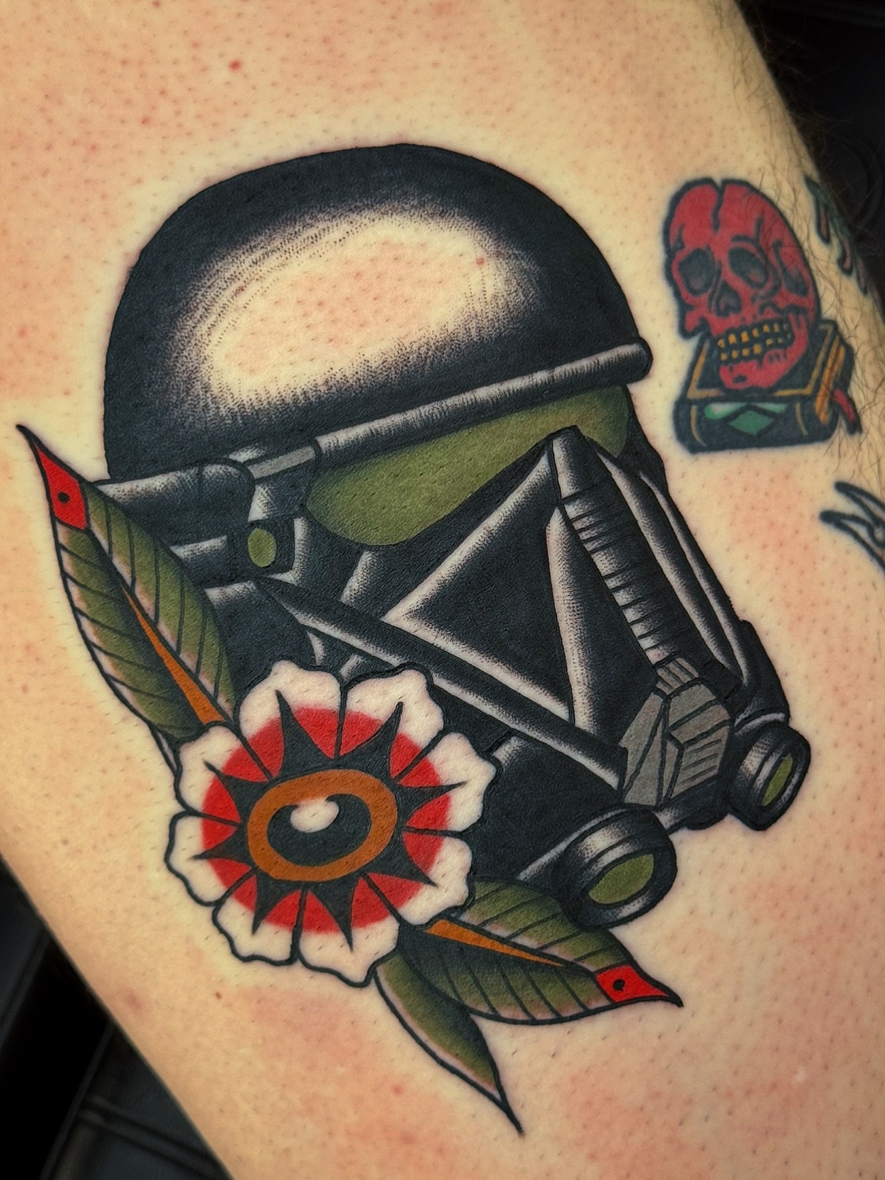 Military helmet and rifle American traditional tattoo on the thigh by Cory Craft