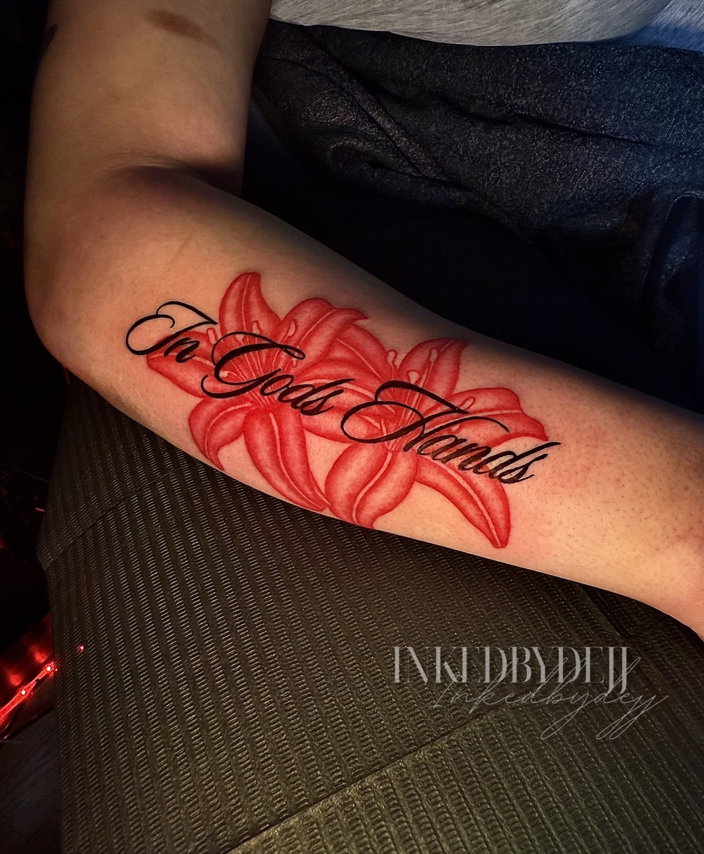 Red lilies realism tattoo on the forearm by Inkedbydejj