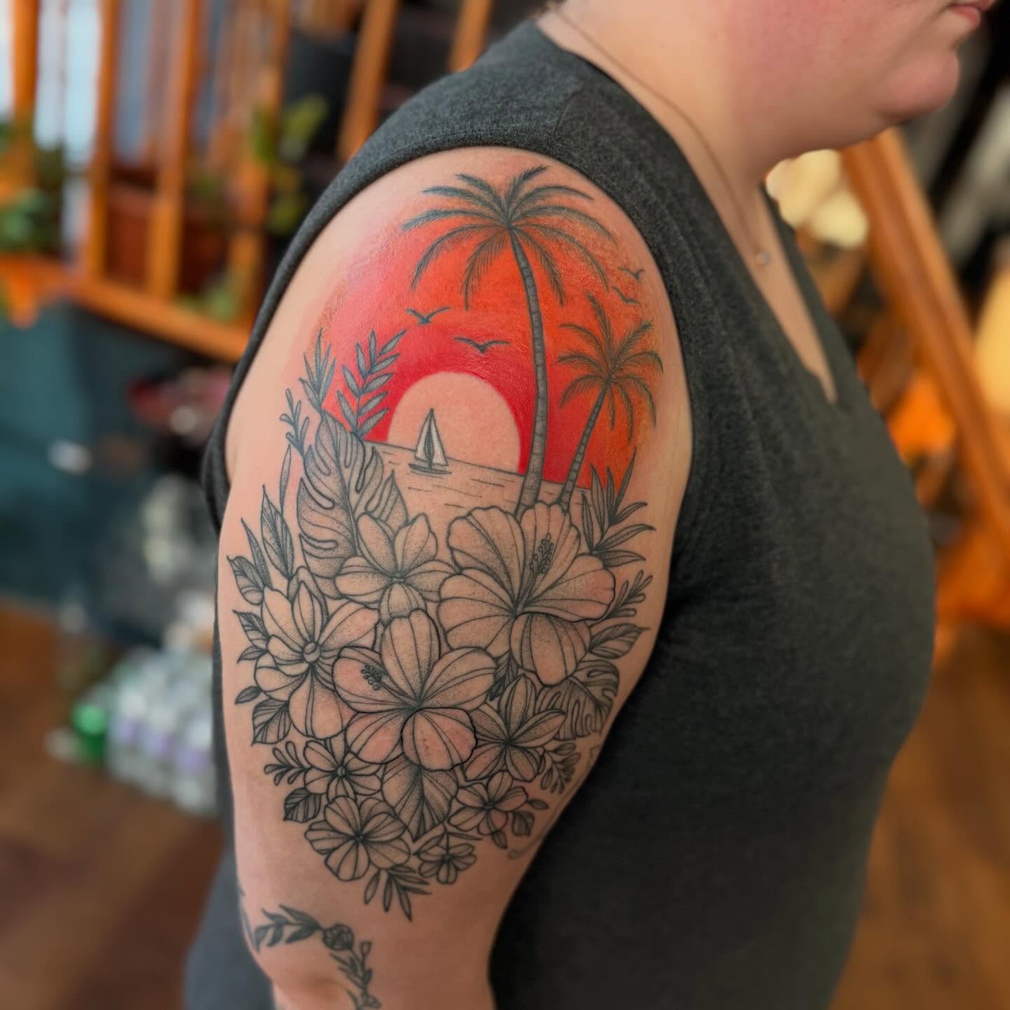 Sunset with flowers and palm trees realism tattoo on the shoulder by Erica Rose π€