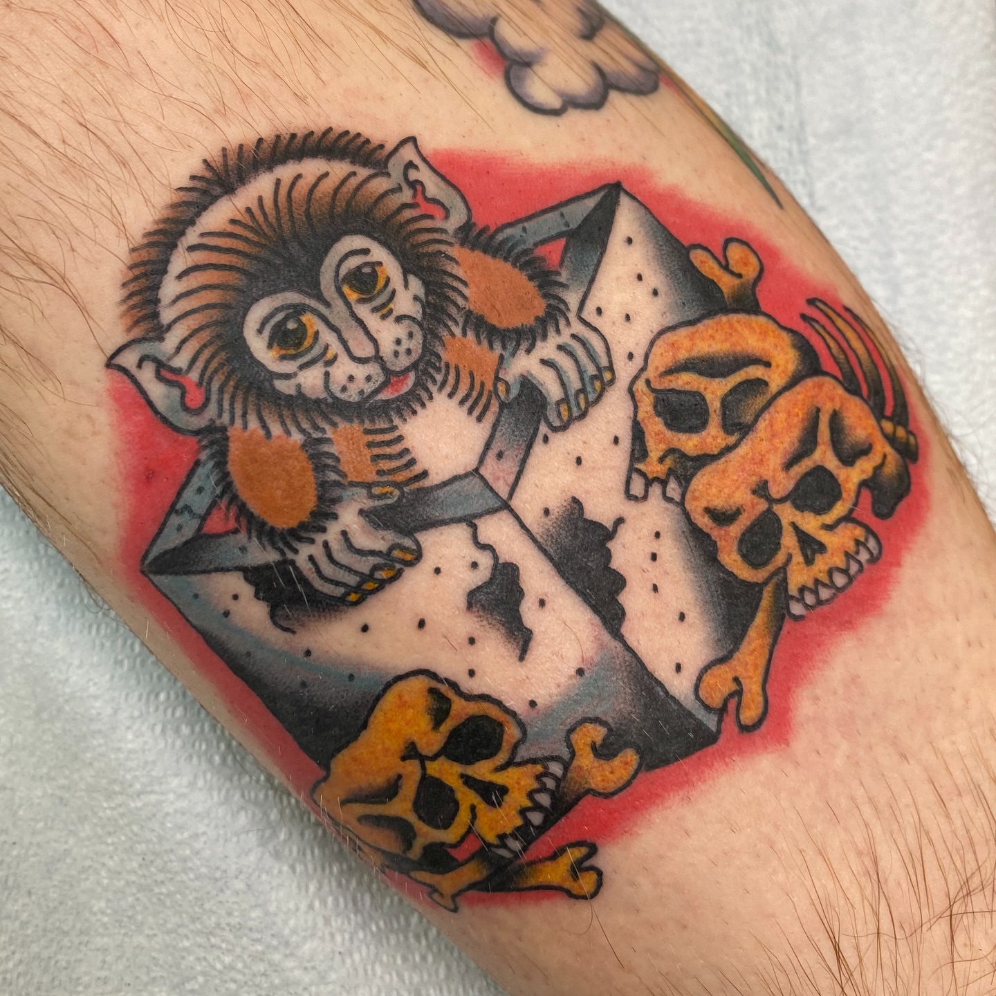 Monkey and skulls American traditional tattoo on the forearm by Mike Tapia