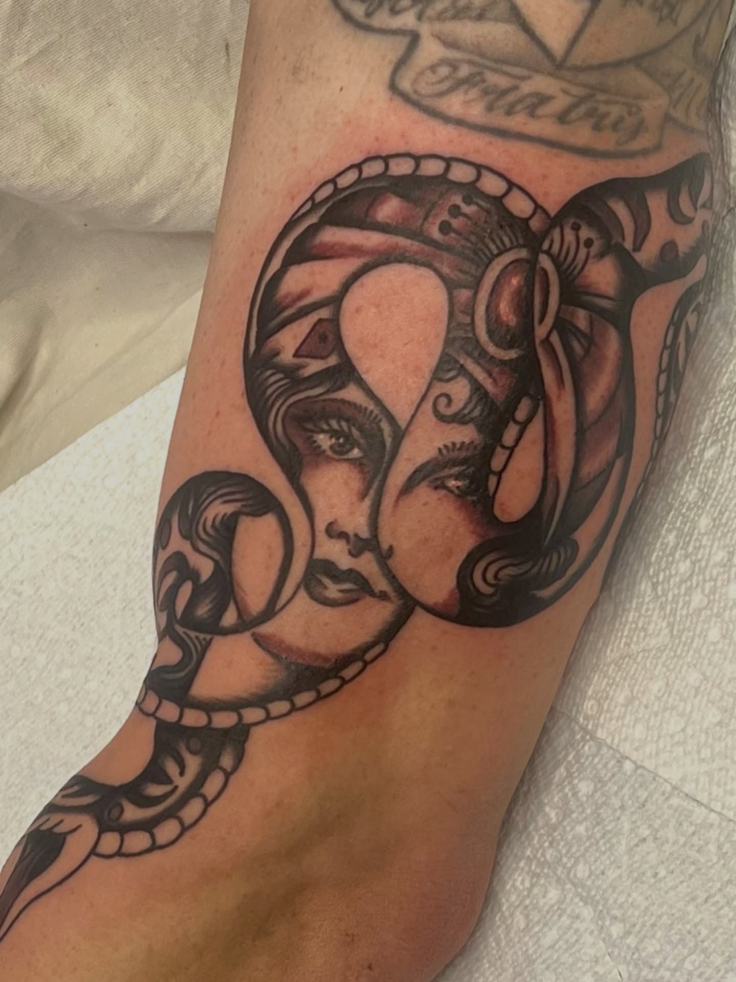 Woman's face with snake American traditional tattoo on the forearm by @brandonhuckabey, Denver, Colorado