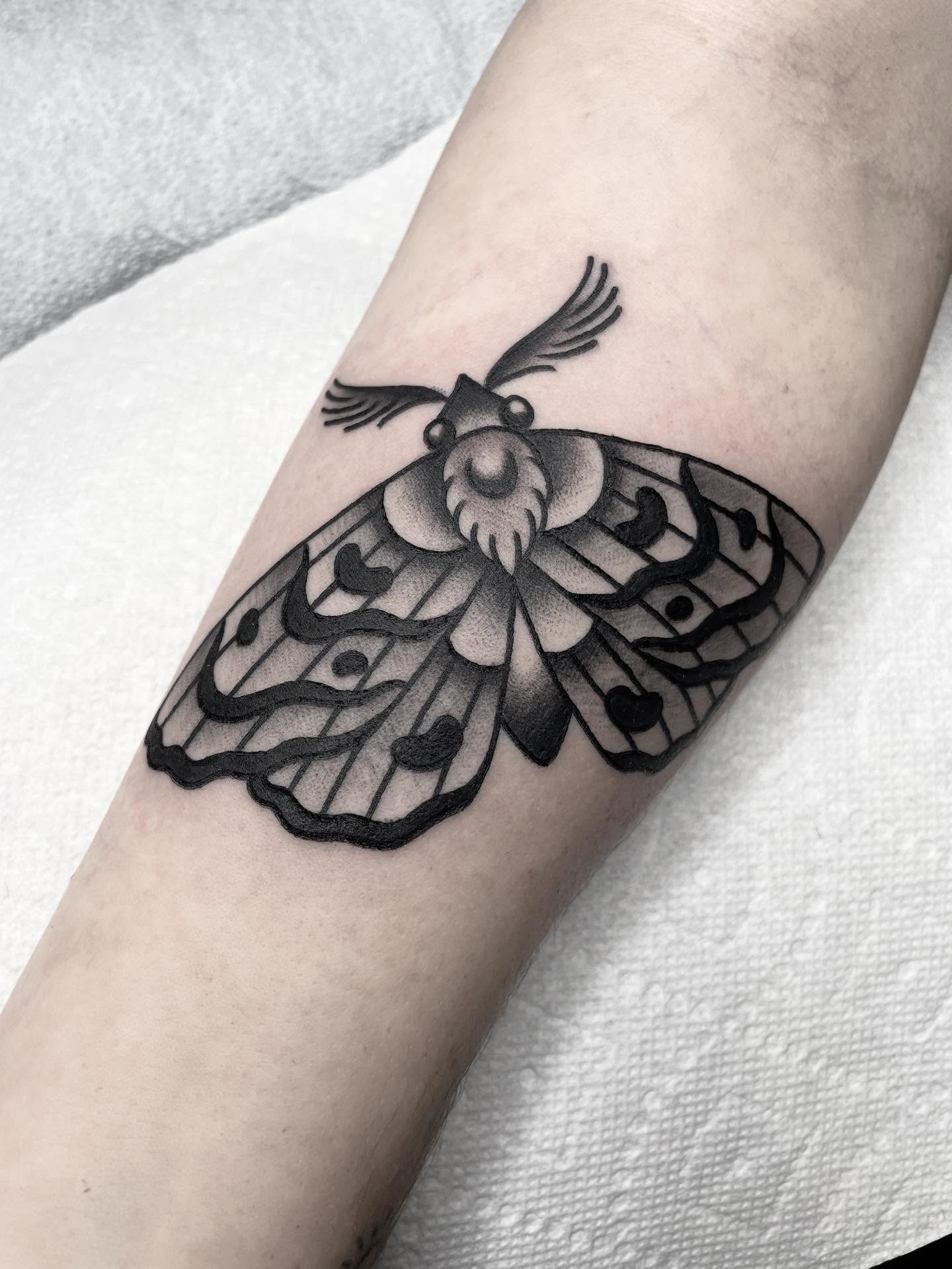 Moth black and grey tattoo on the forearm by Kat, Sacramento, California