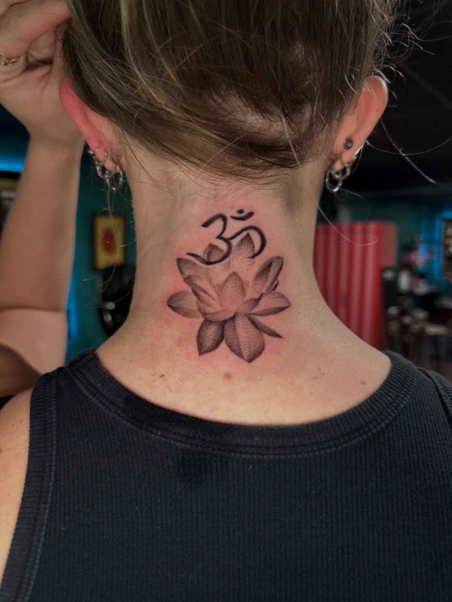 Lotus flower and om symbol black and grey tattoo on the neck by Mario Flores Tattoo