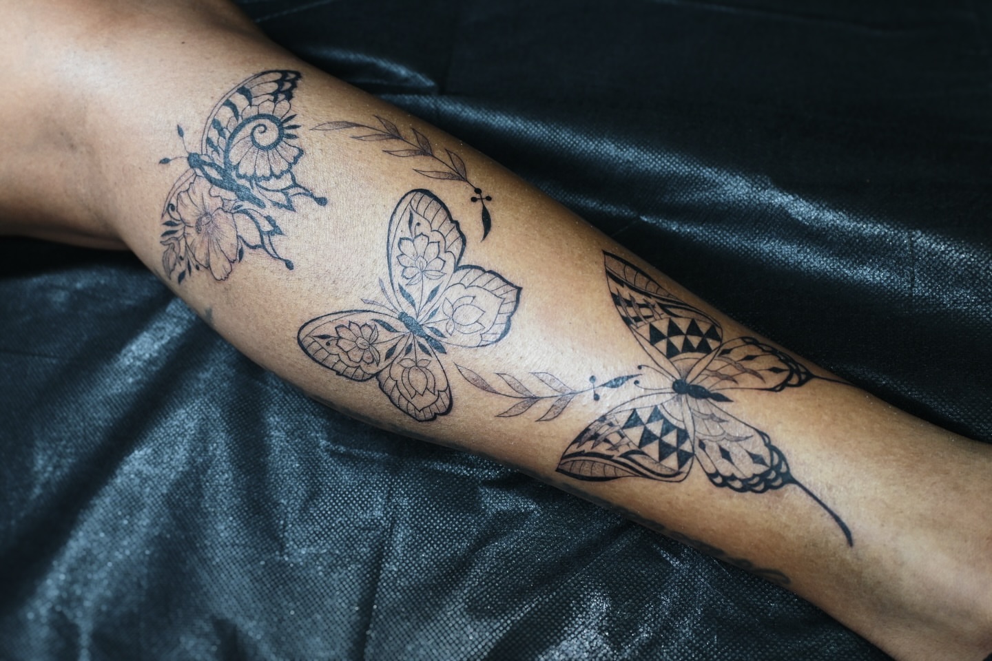 Butterflies black and grey tattoo on the forearm by Sabreena Haque