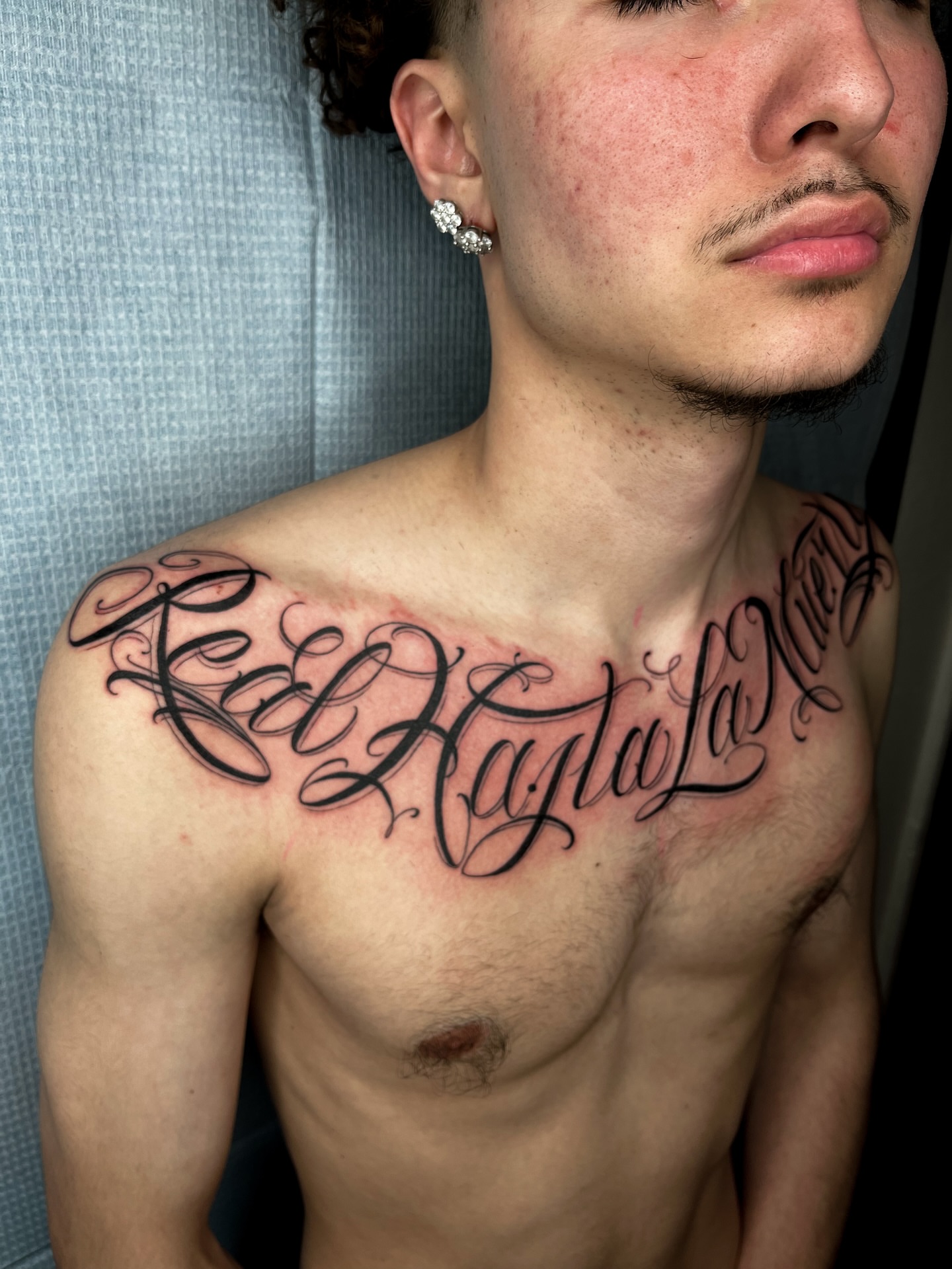 Script lettering lettering script tattoo on the chest by The One Who’s Always Drawing